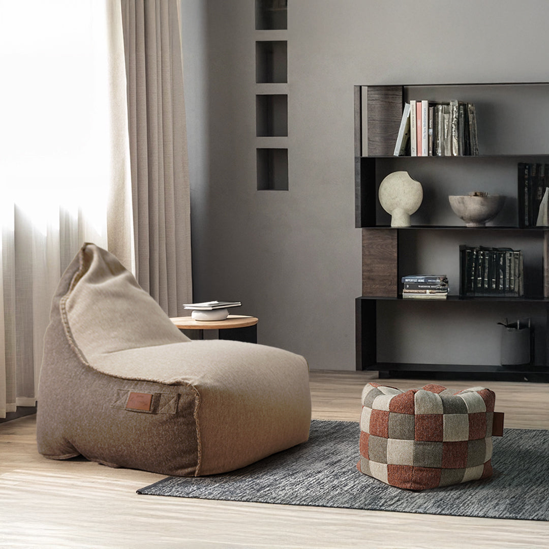 Multi-color Olefin pouf by BEACON, a versatile fabric seat or footrest with vibrant, patterned design.