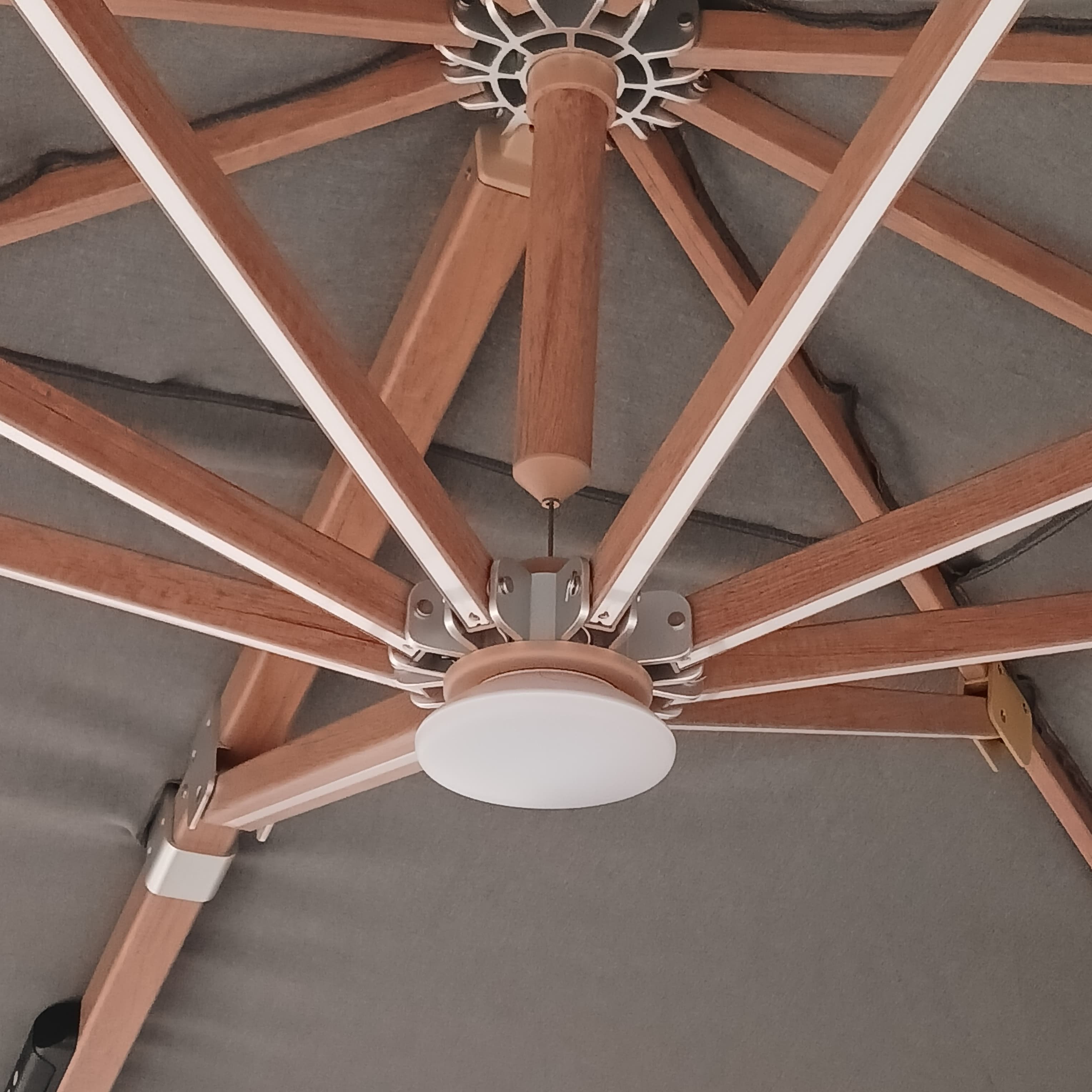 BEACON Opal cantilever outdoor umbrella with matching base, showcasing its large canopy and sturdy support structure.