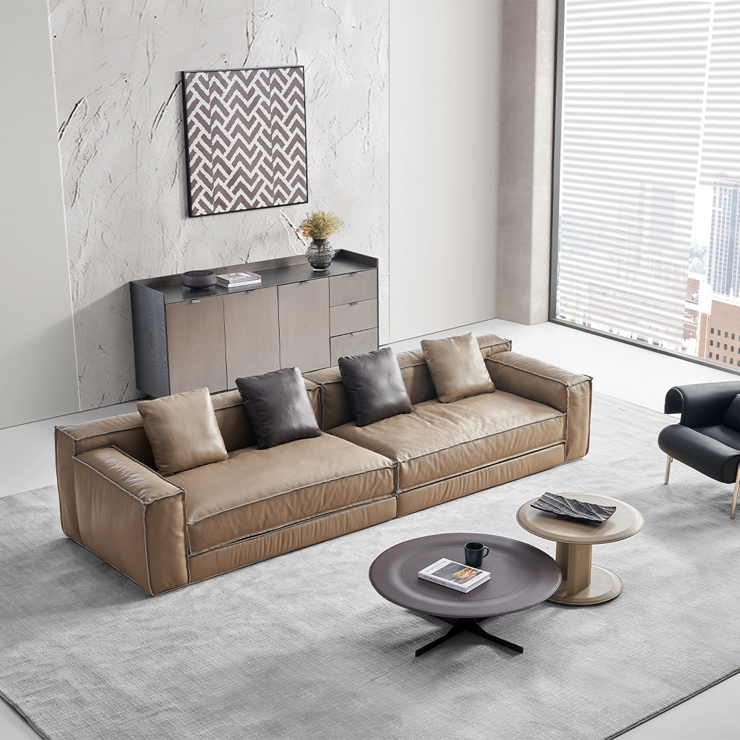 Orbit Lux brown saddle leather coffee table by BEACON featuring a sleek leather surface and modern design.