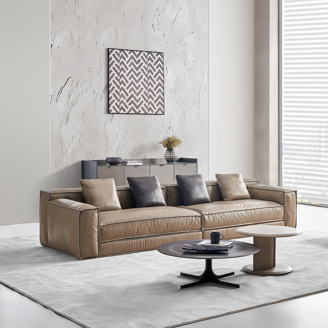 Orbit Lux brown saddle leather coffee table by BEACON with a sleek, modern design and sturdy wooden legs.