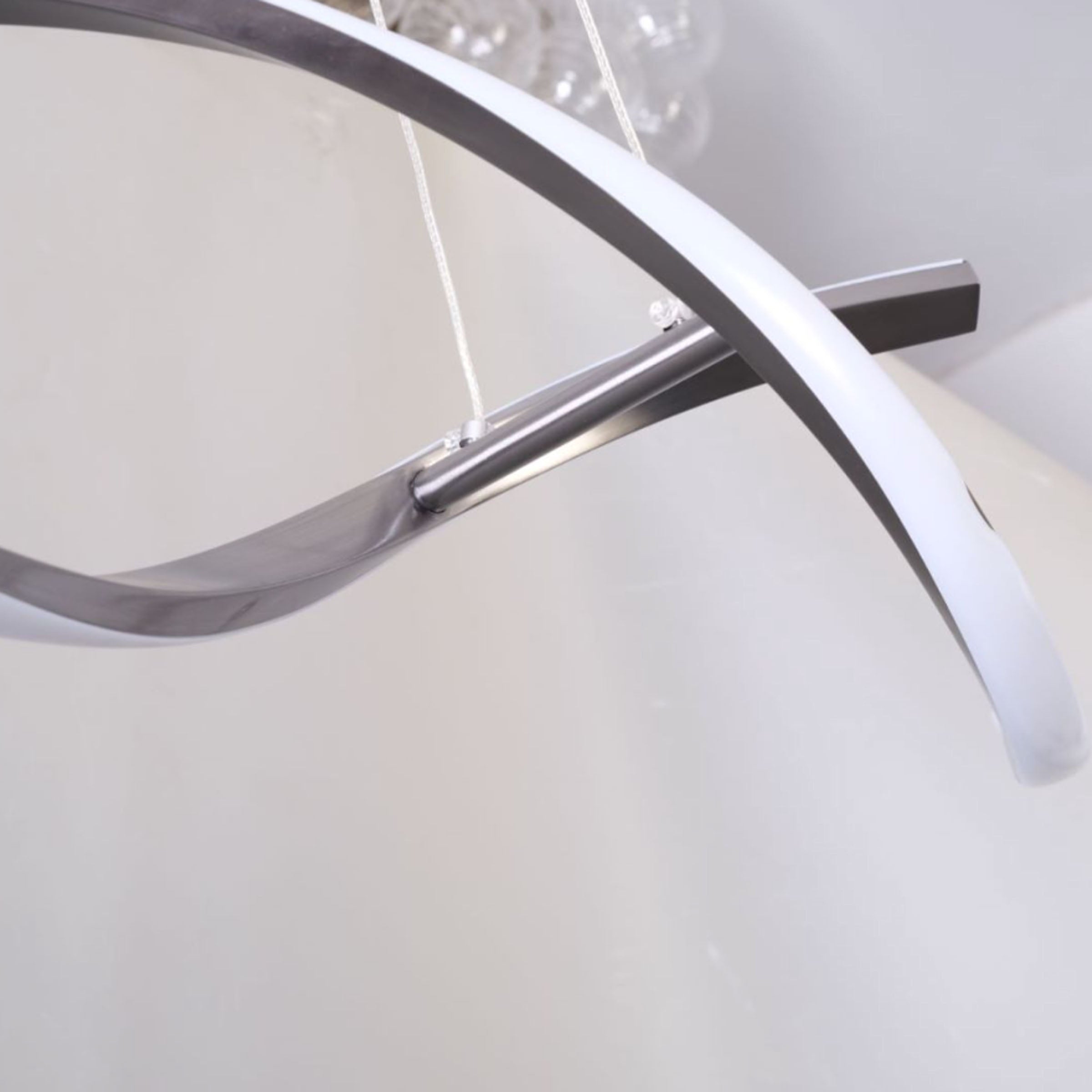 BEACON Orbital Symphony Steel Pendant Lamp hanging with a sleek, modern design and multiple circular metal rings.