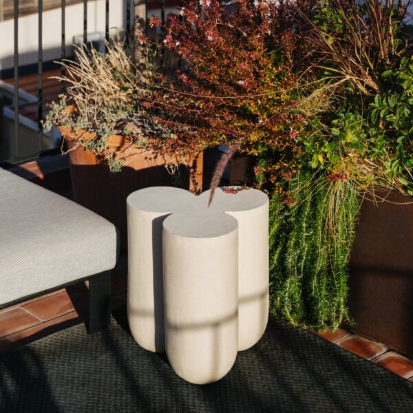 Beige outdoor and indoor seating bench by BEACON, versatile pouf with cushioned top and sturdy legs for indoor or outdoor use.
