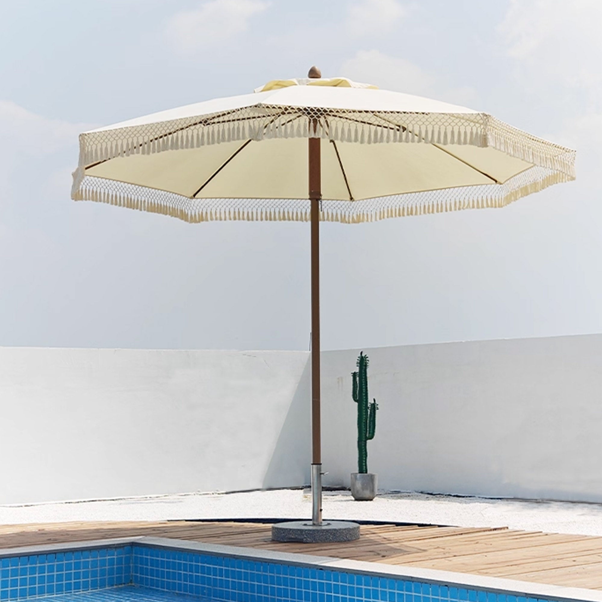 Beacon outdoor center pole umbrella with push-up and down system, showing the beige fabric canopy and sturdy metal pole.