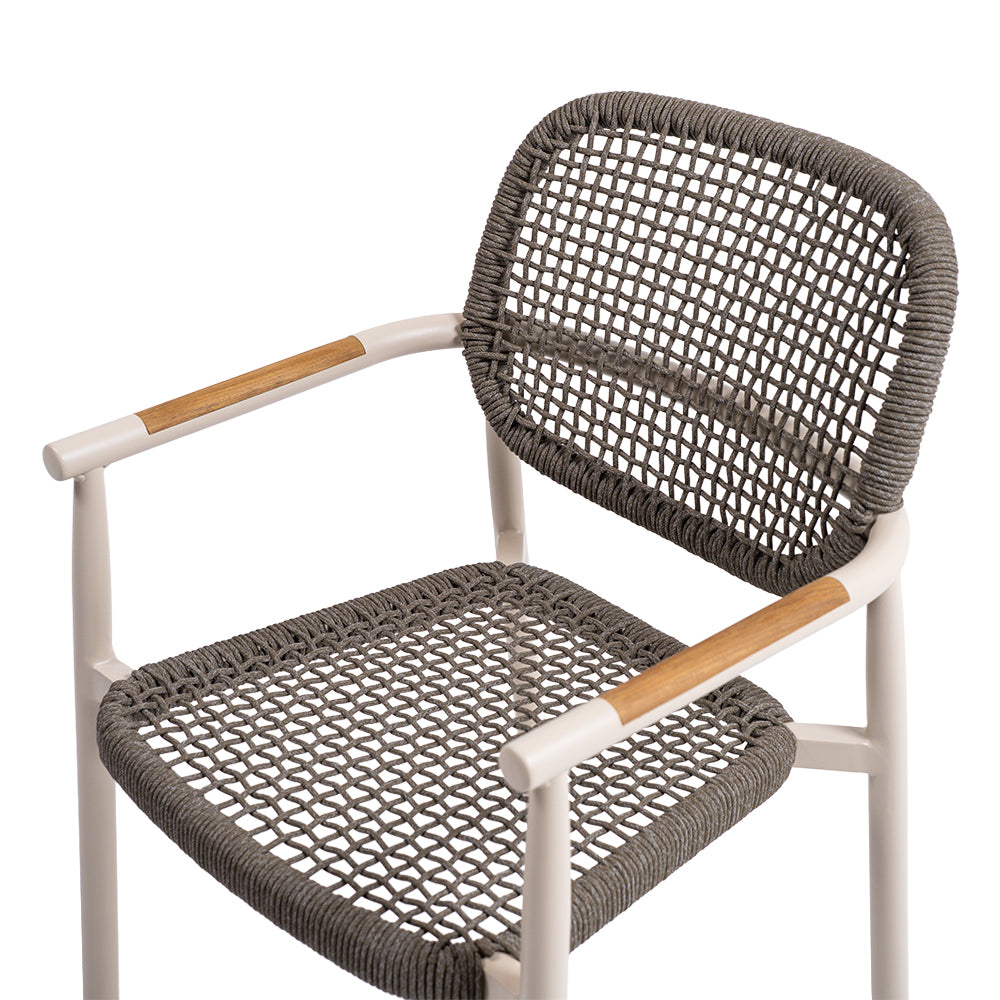 Modern dining armchair with woven rope detail by Beacon, featuring a sleek design and comfortable seating in natural tones.