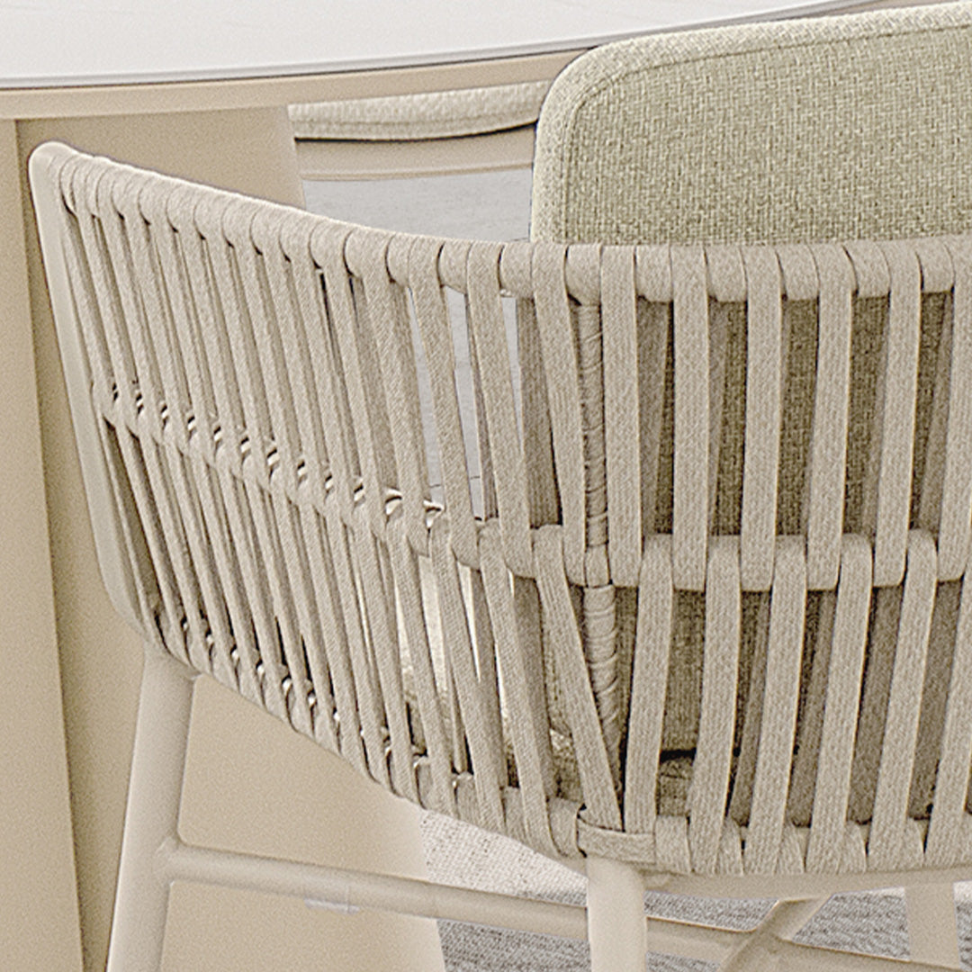 Marrakech outdoor dining armchair by BEACON, featuring a woven rattan design and sturdy metal frame for outdoor use.