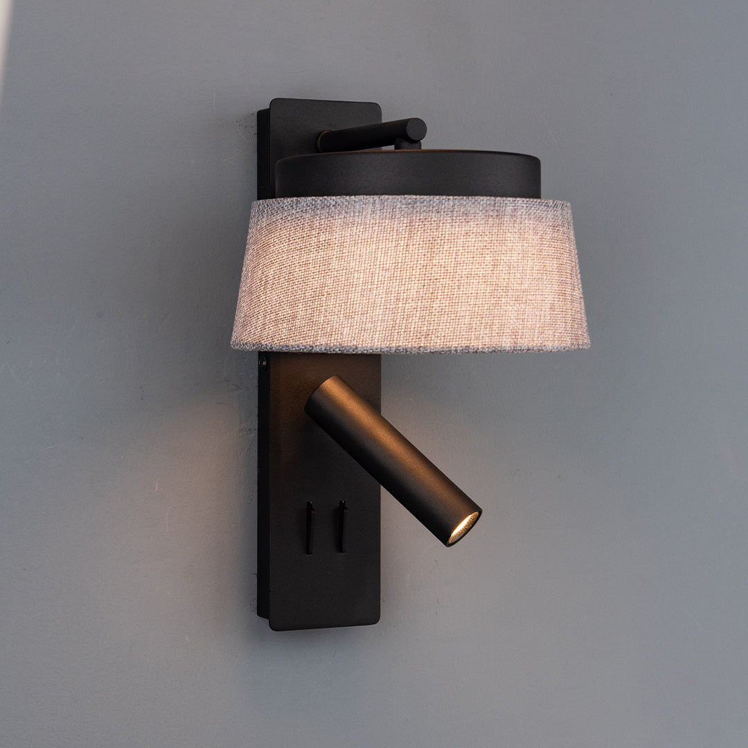 Black and grey linen shade wall reading lamp from BEACON, hotel style headboard wall lamp with sleek design and adjustable arm.