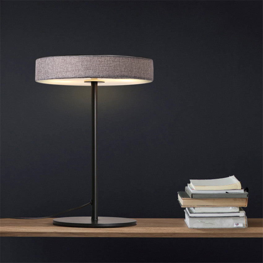Crescent LED aluminum fabric table lamp by BEACON, 45x30 cm modern desk lamp with sleek crescent design in a stylish setting.
