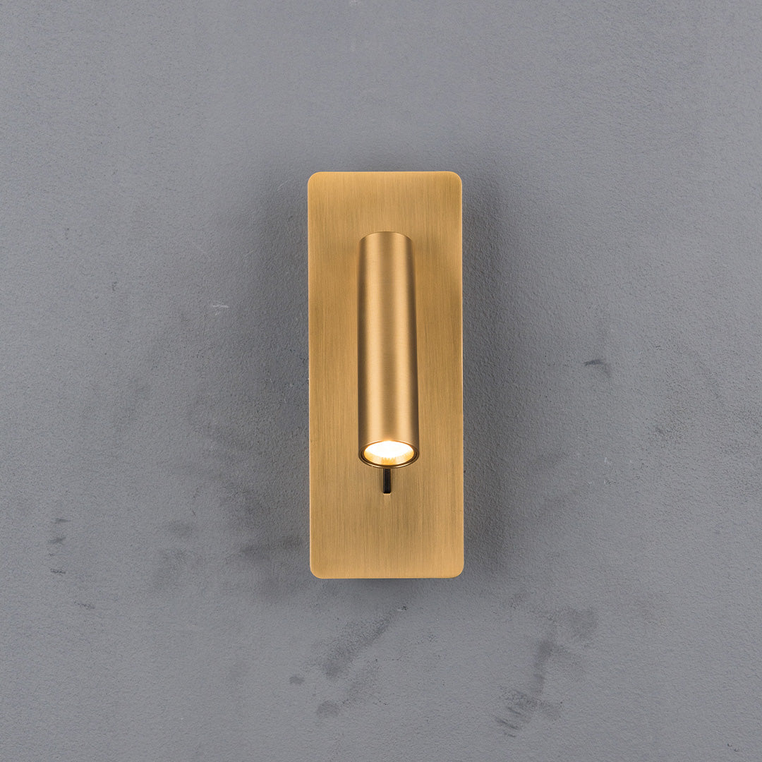 BEACON Gemini hotel-style wall reading lamp mounted on headboard, featuring sleek design and adjustable arm for focused lighting.