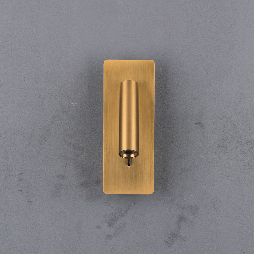 BEACON Gemini hotel-style wall reading lamp with adjustable arm and brown finish, mounted on a headboard for bedside lighting.