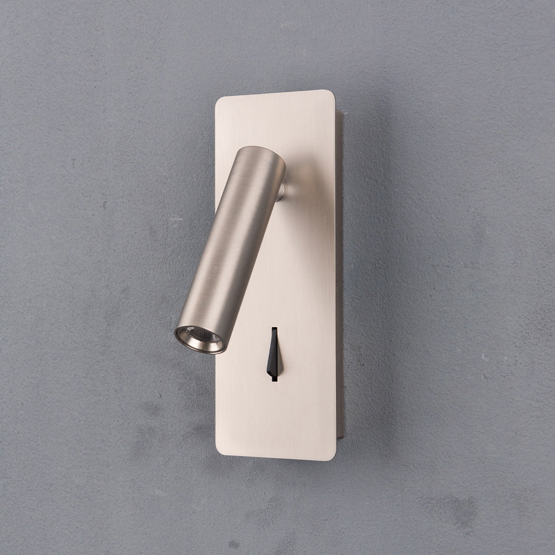 Gemini Hotel Style Wall Reading Lamp by BEACON mounted on a wall, featuring sleek design and adjustable lighting for hotel headboards.