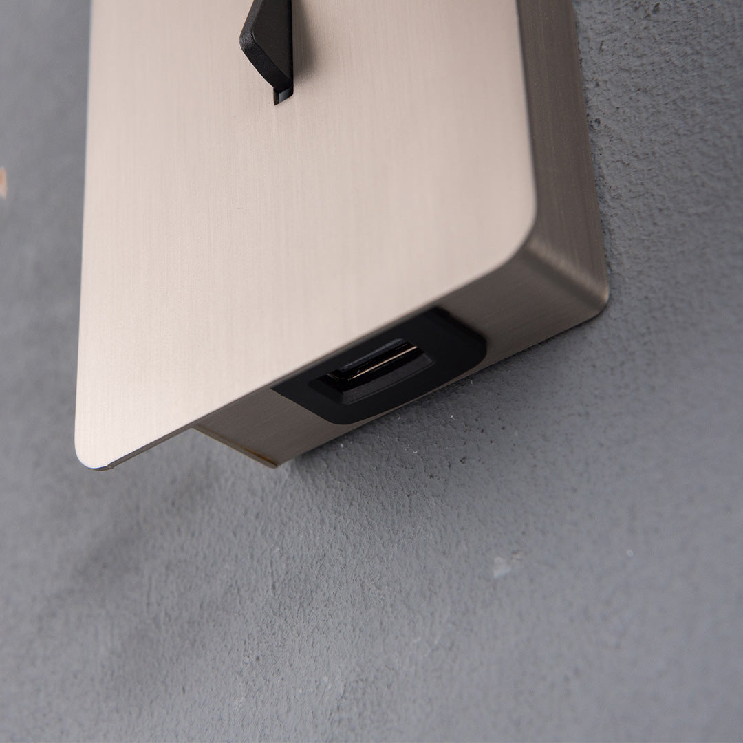 BEACON Gemini hotel style wall reading lamp mounted on headboard, featuring sleek design and adjustable arm for bedside lighting.
