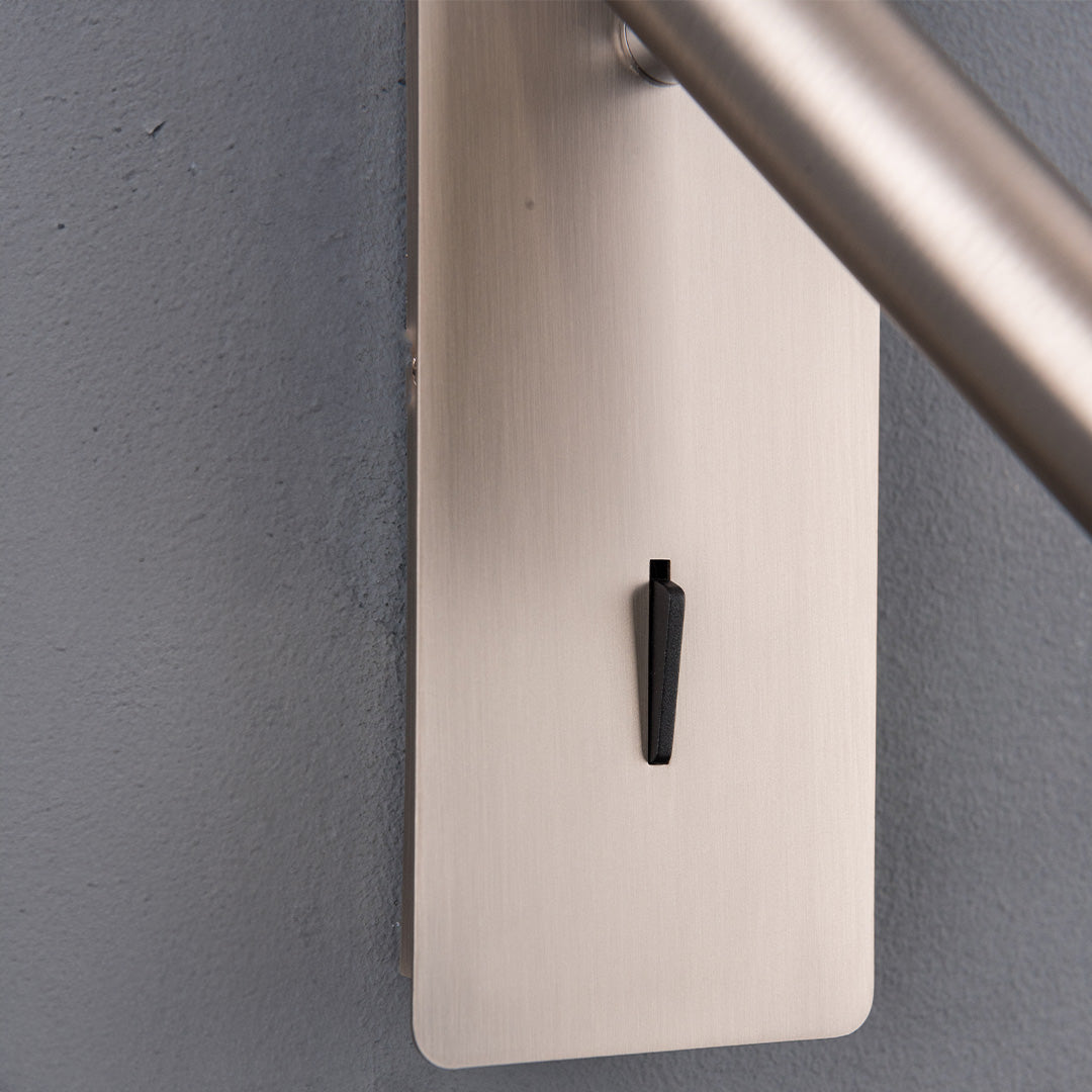 BEACON Gemini Hotel Style Wall Reading Lamp mounted on headboard, with sleek design and adjustable arm for bedside lighting.