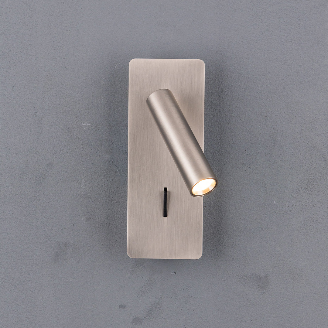 BEACON Gemini hotel-style wall reading lamp mounted on a headboard, featuring sleek design and adjustable arm for reading light.