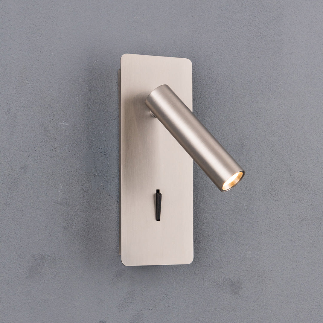 BEACON Gemini hotel-style wall reading lamp with adjustable arm, mounted on a headboard, in a modern black finish.