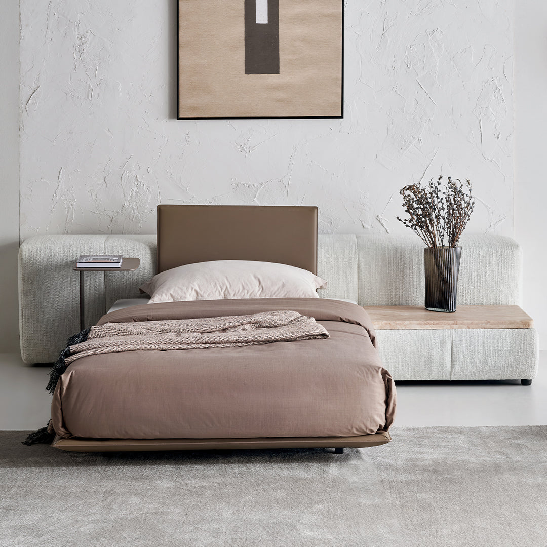 Puzzle headboard and long back sofa unit from BEACON bedstead collection, featuring a modern design and comfortable seating.