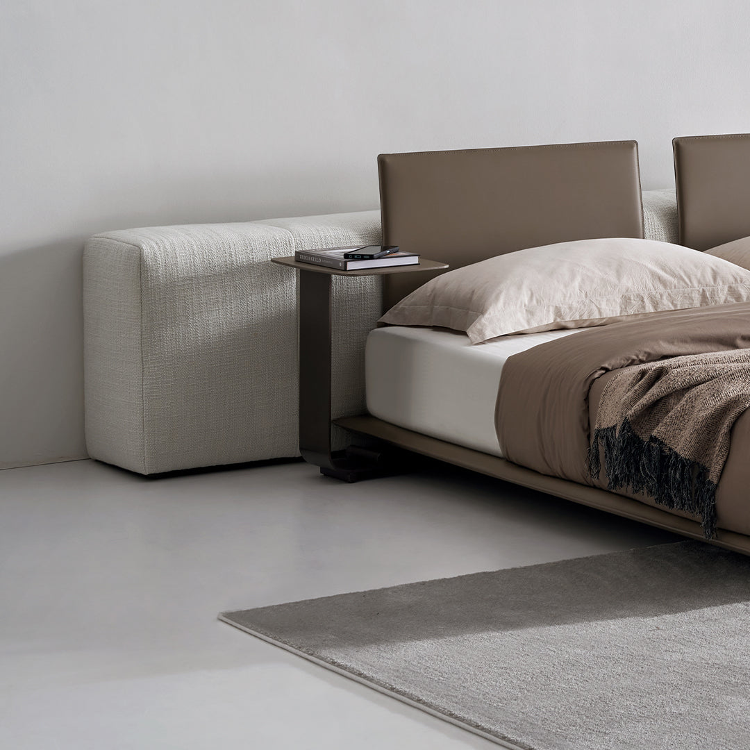 Modular bronze side table from BEACON, designed for sofas, with a puzzle-inspired geometric shape and sleek finish.