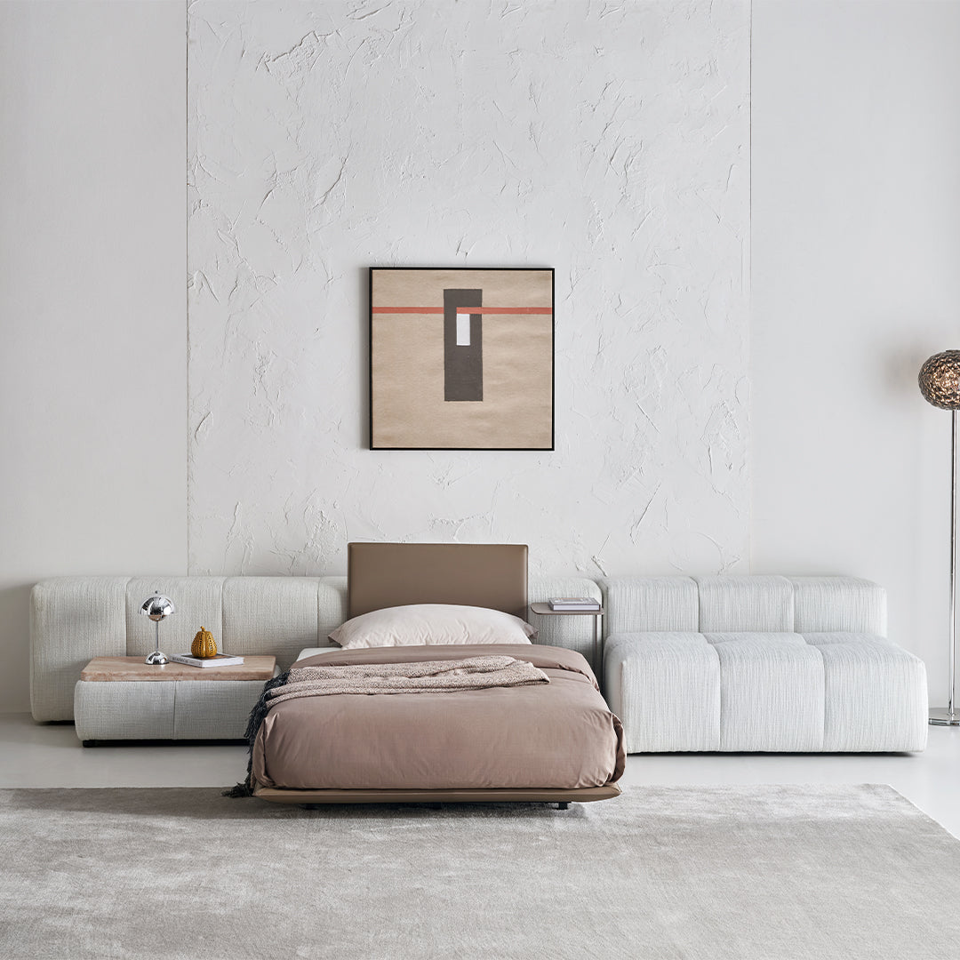 BEACON Puzzle Suspended Single Bed Base with One Backrest, modern bedstead in a sleek design, shown from a side angle.