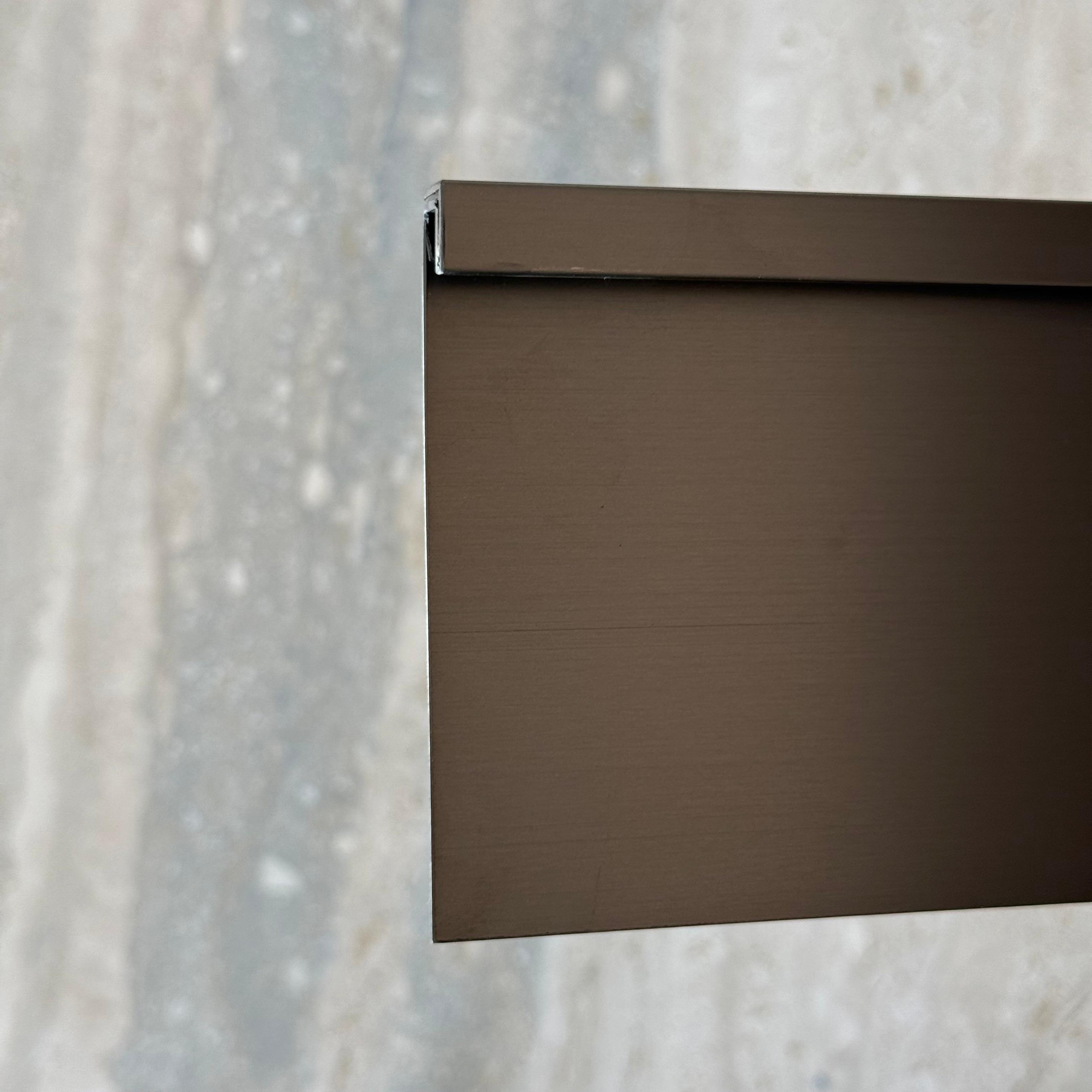 Black R0 10cm external corner skirting accessory by BEACON for wall panels and profiles, shown on a wall installation.