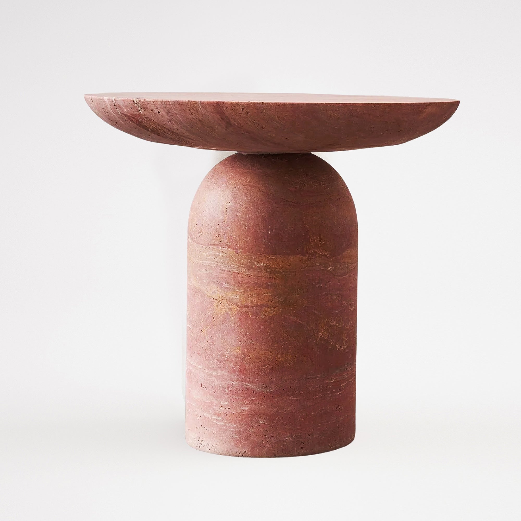 Red travertine side table by BEACON, stylish and compact with a smooth stone surface and modern design.