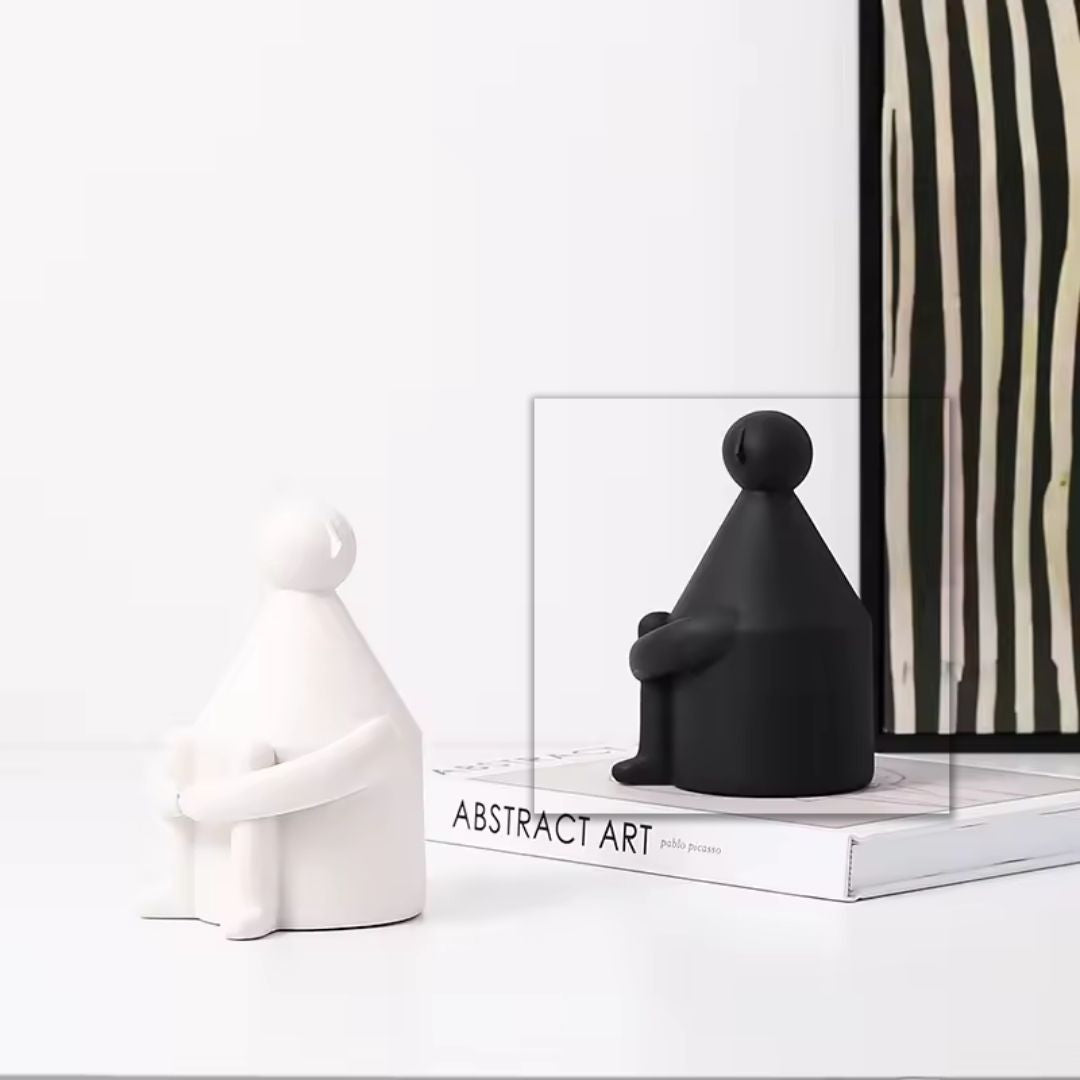 White man round-head BEACON home decor figurine with black accents, stylish black and white sculpture for interior decor.