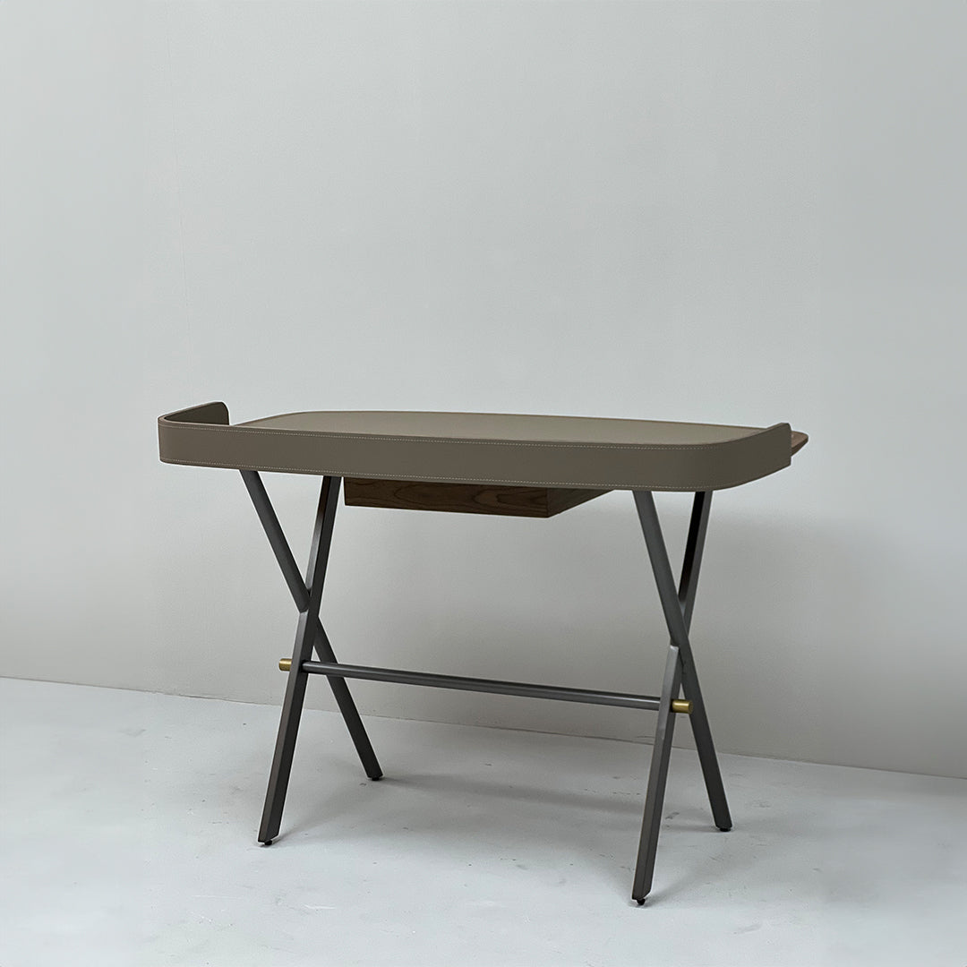 Saddle leather office desk by BEACON, featuring a sleek design with a smooth leather surface and sturdy wooden legs.