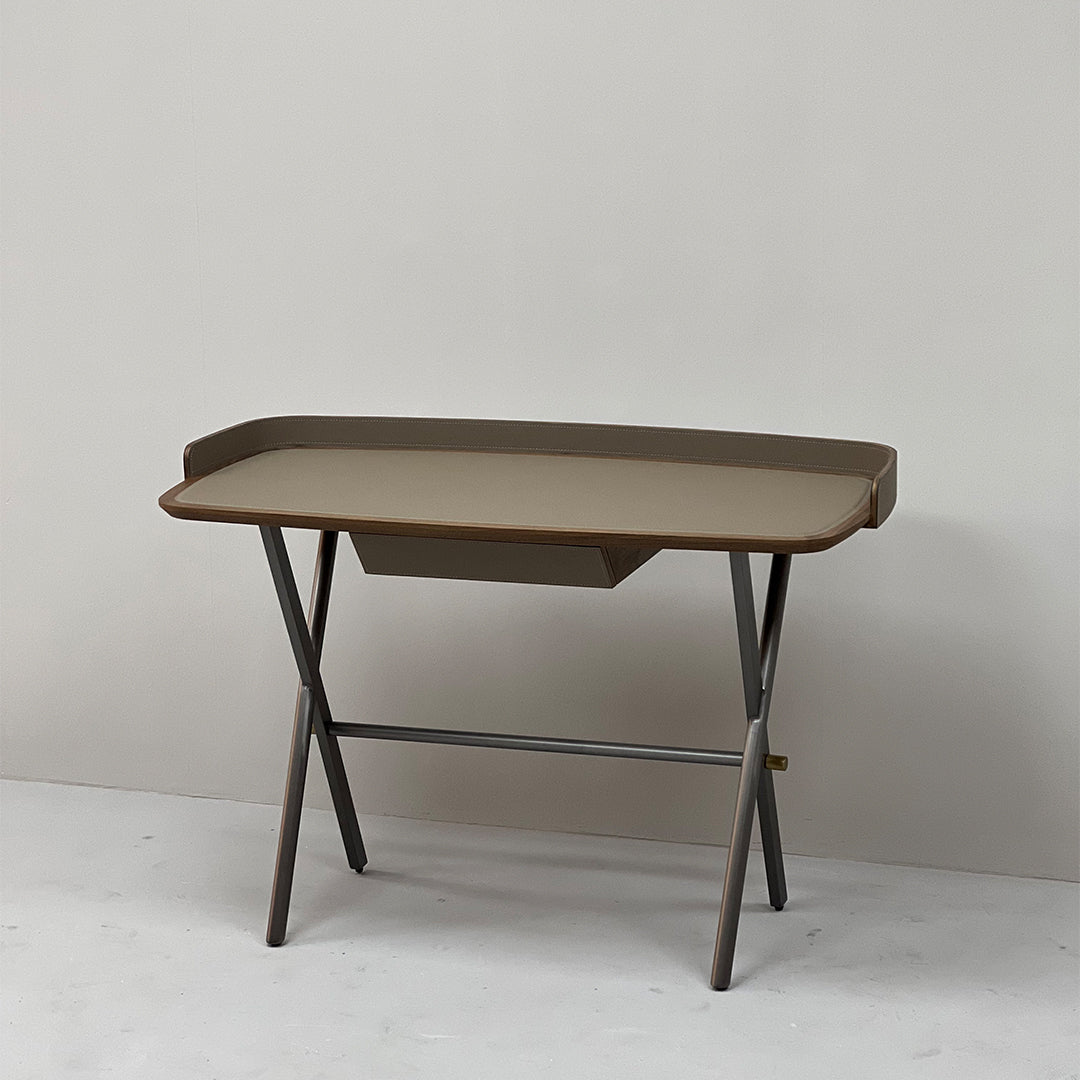 Beige saddle leather office desk with sleek wooden legs, modern design, ideal for professional workspace.