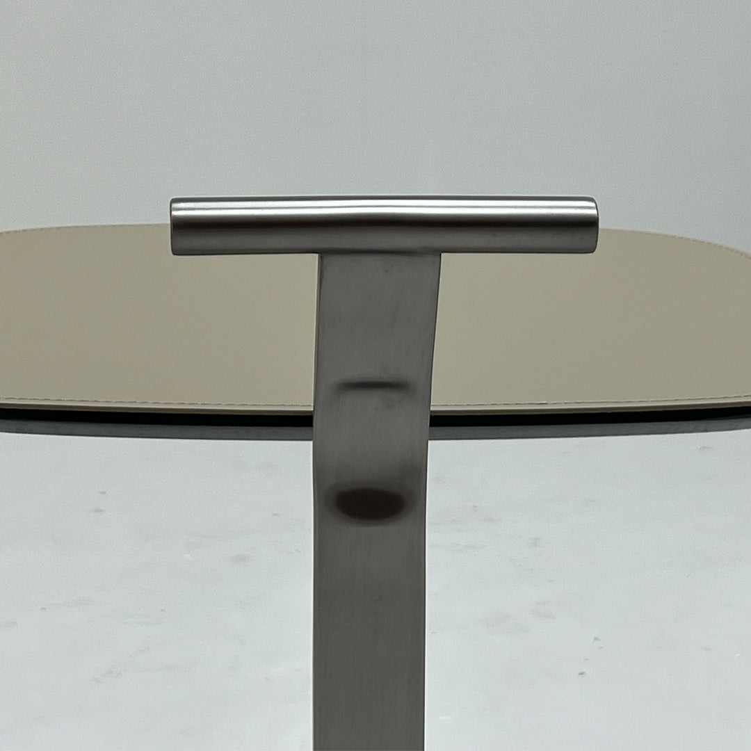 Saddle leather side table with sleek wooden legs, modern design, and smooth leather surface by BEACON.