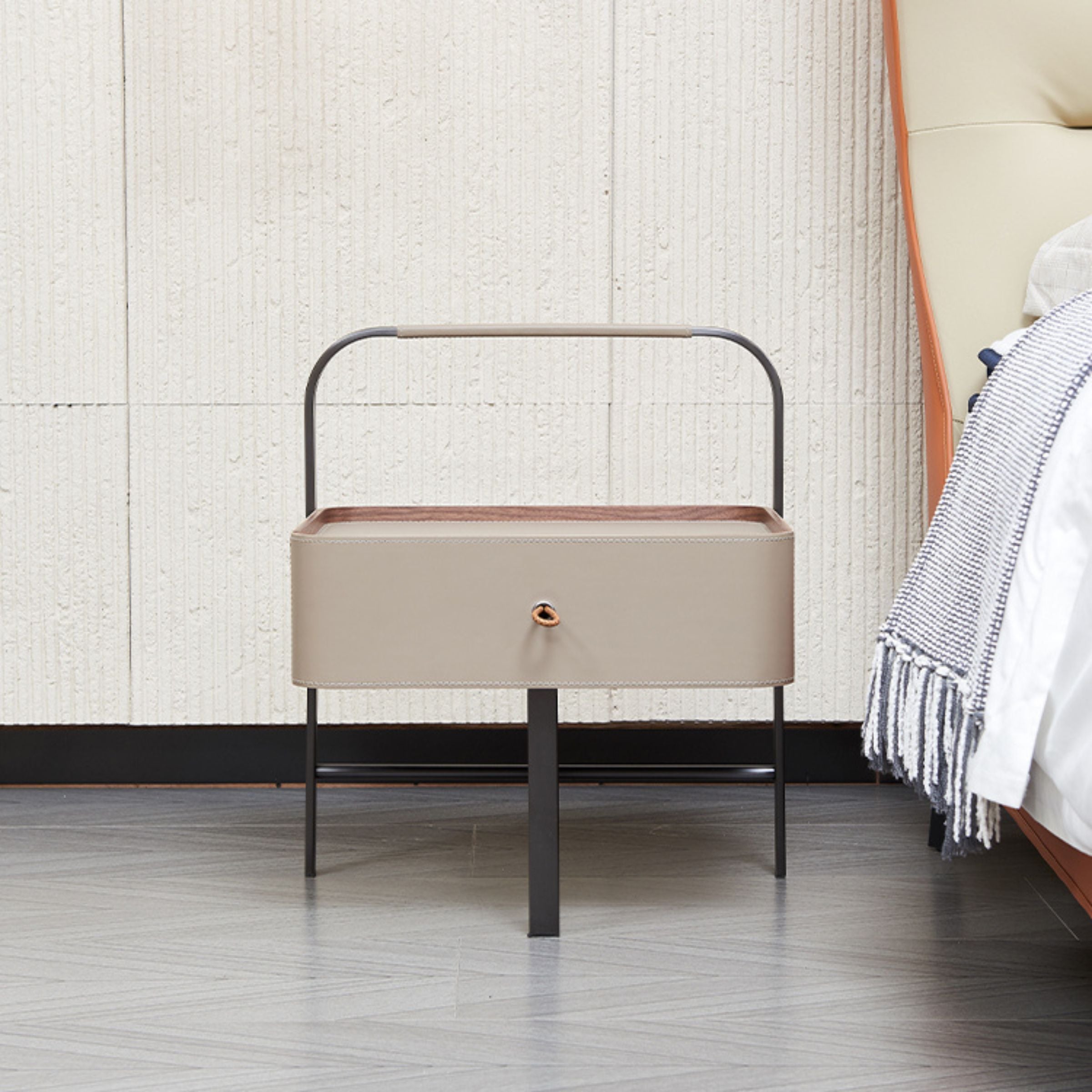 Beige saddle leather side table with wooden legs, modern design, perfect for living room or bedroom decor.