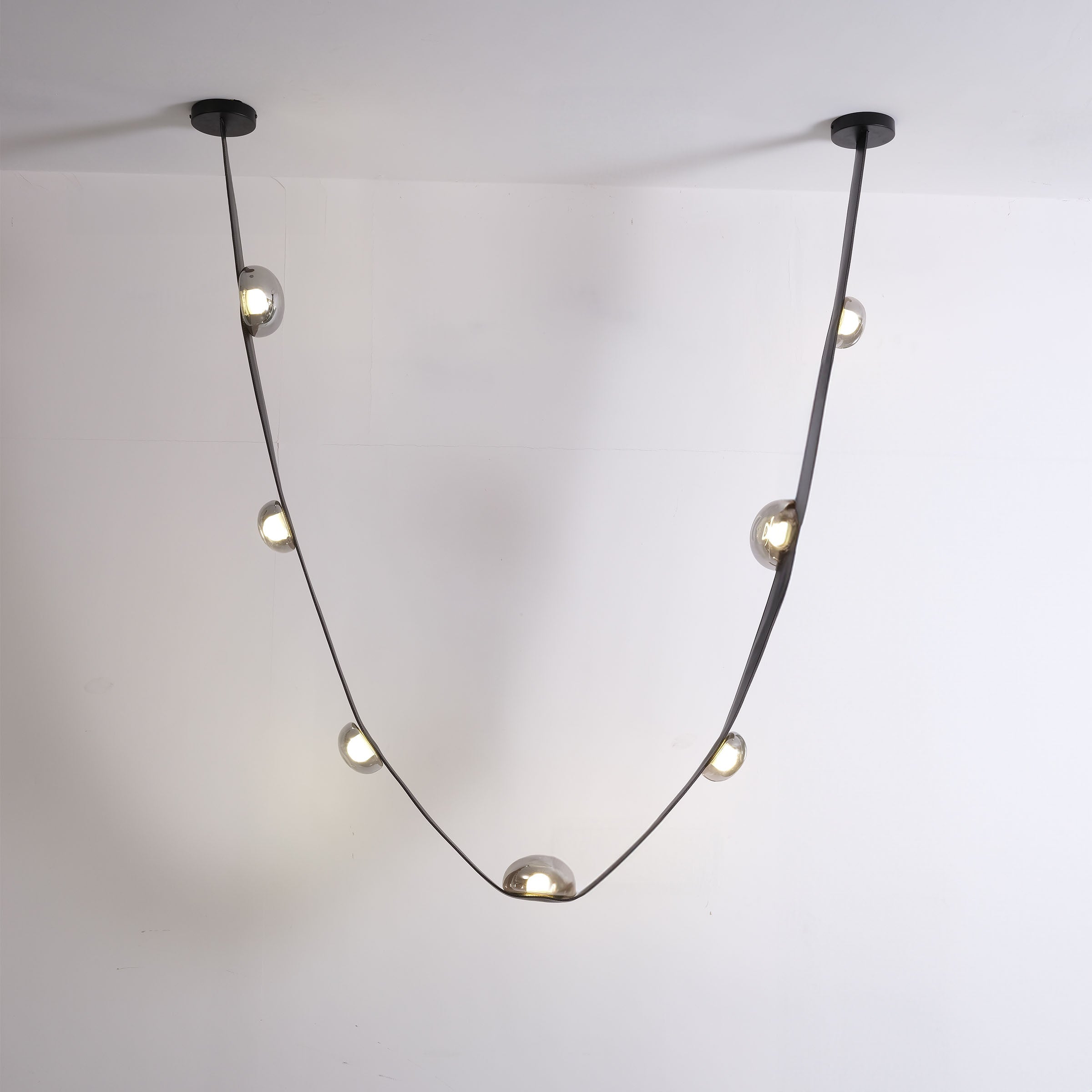 Set of 3 BEACON Whispering Stars pendant lamps in different sizes with star-shaped designs, hanging fixtures for modern decor.