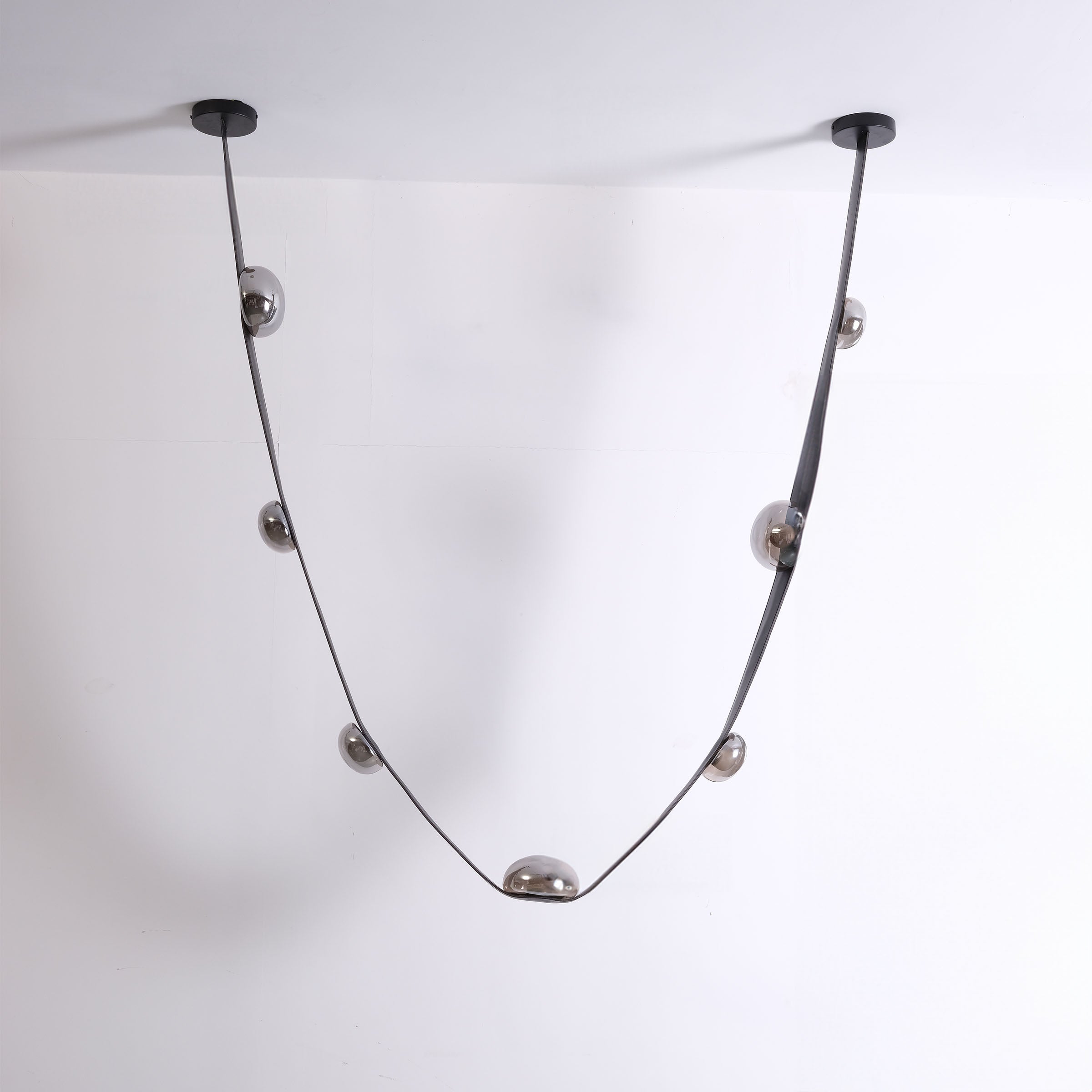 Set of 3 BEACON Whispering Stars pendant lamps in different sizes, featuring star-shaped designs and sleek metallic finishes.