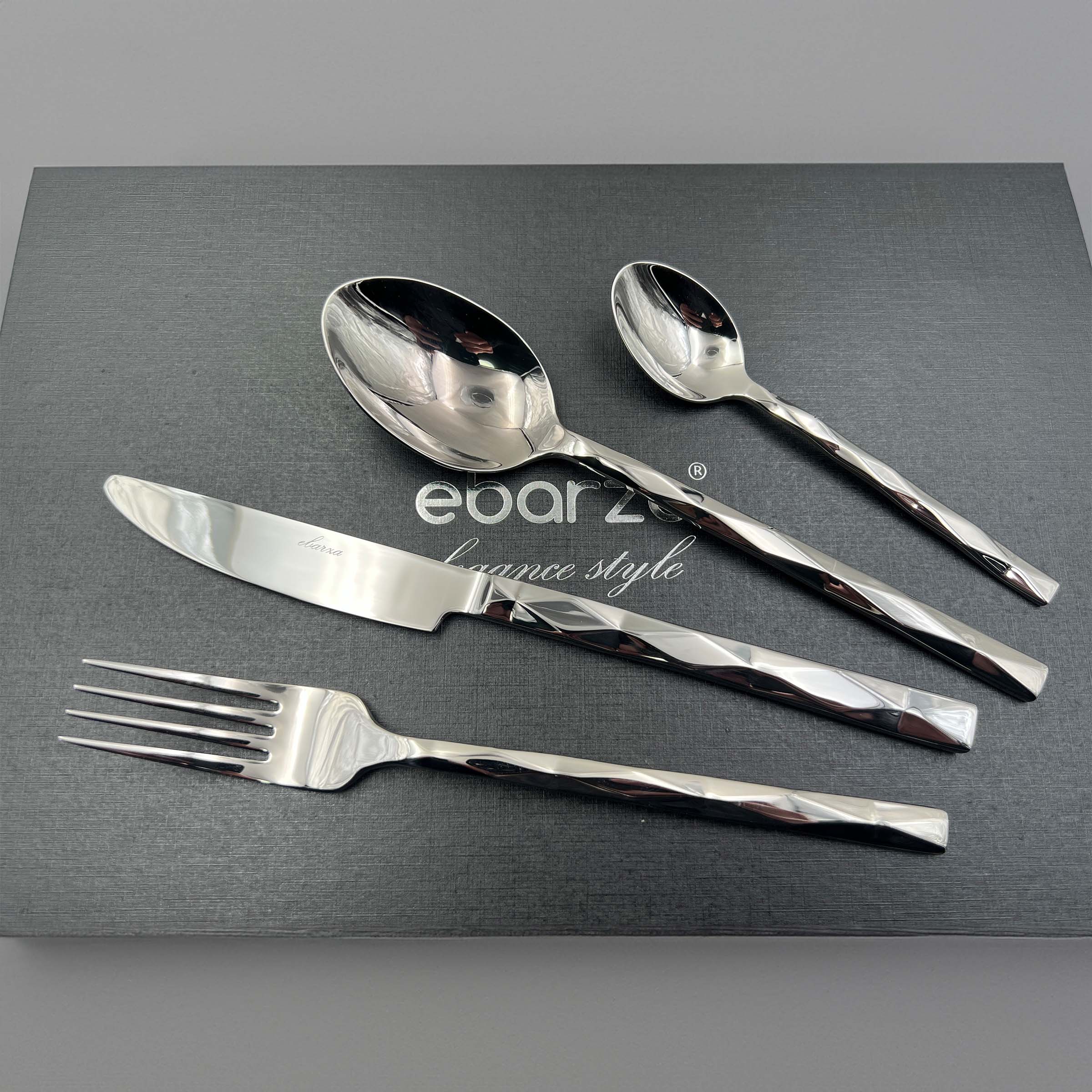 Silhouette set of 24 mirror silver cutlery pieces by BEACON, including forks, knives, and spoons for dining and serving.