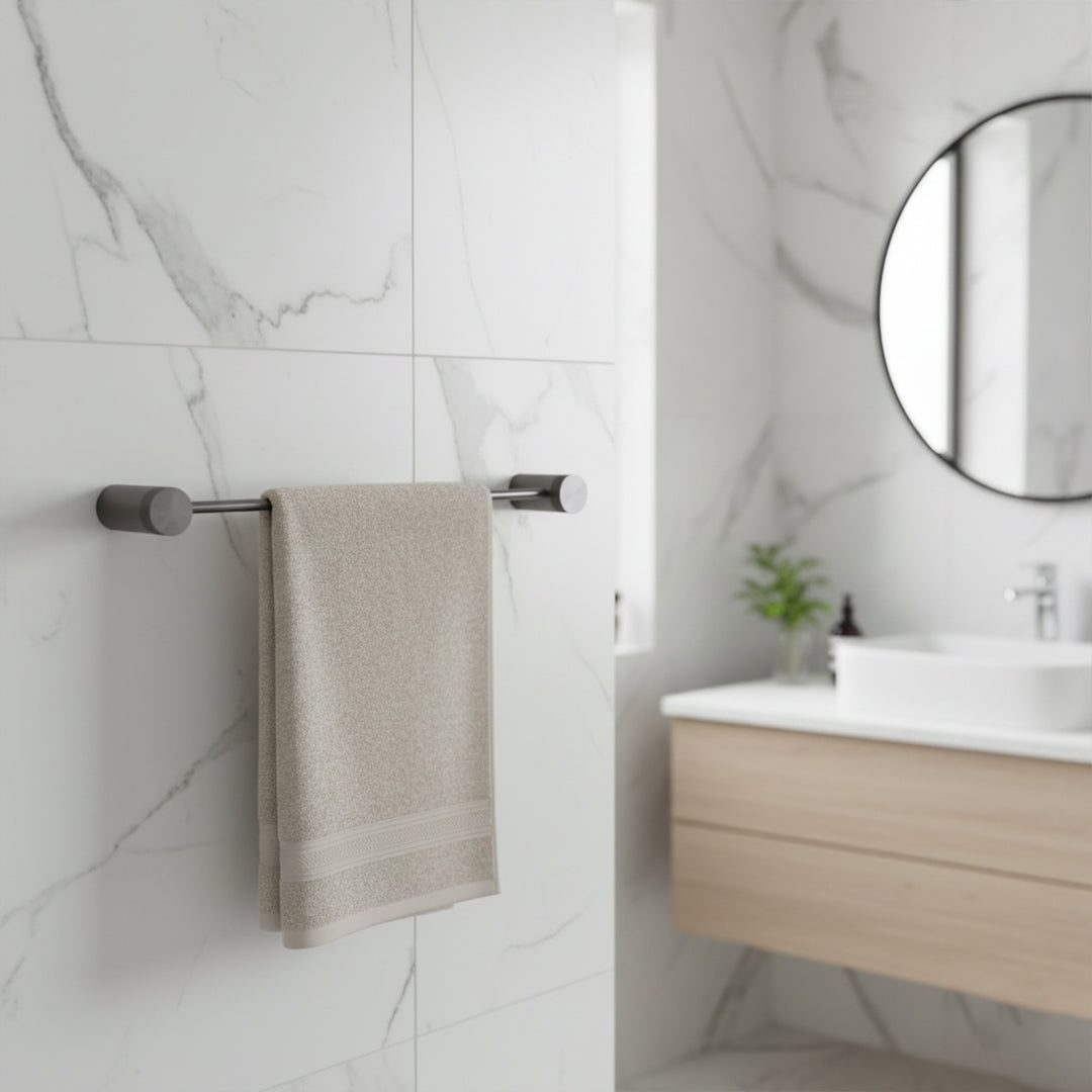 Brass single towel bar from BEACON bathroom accessories, sleek and modern design for holding towels in a bathroom space.