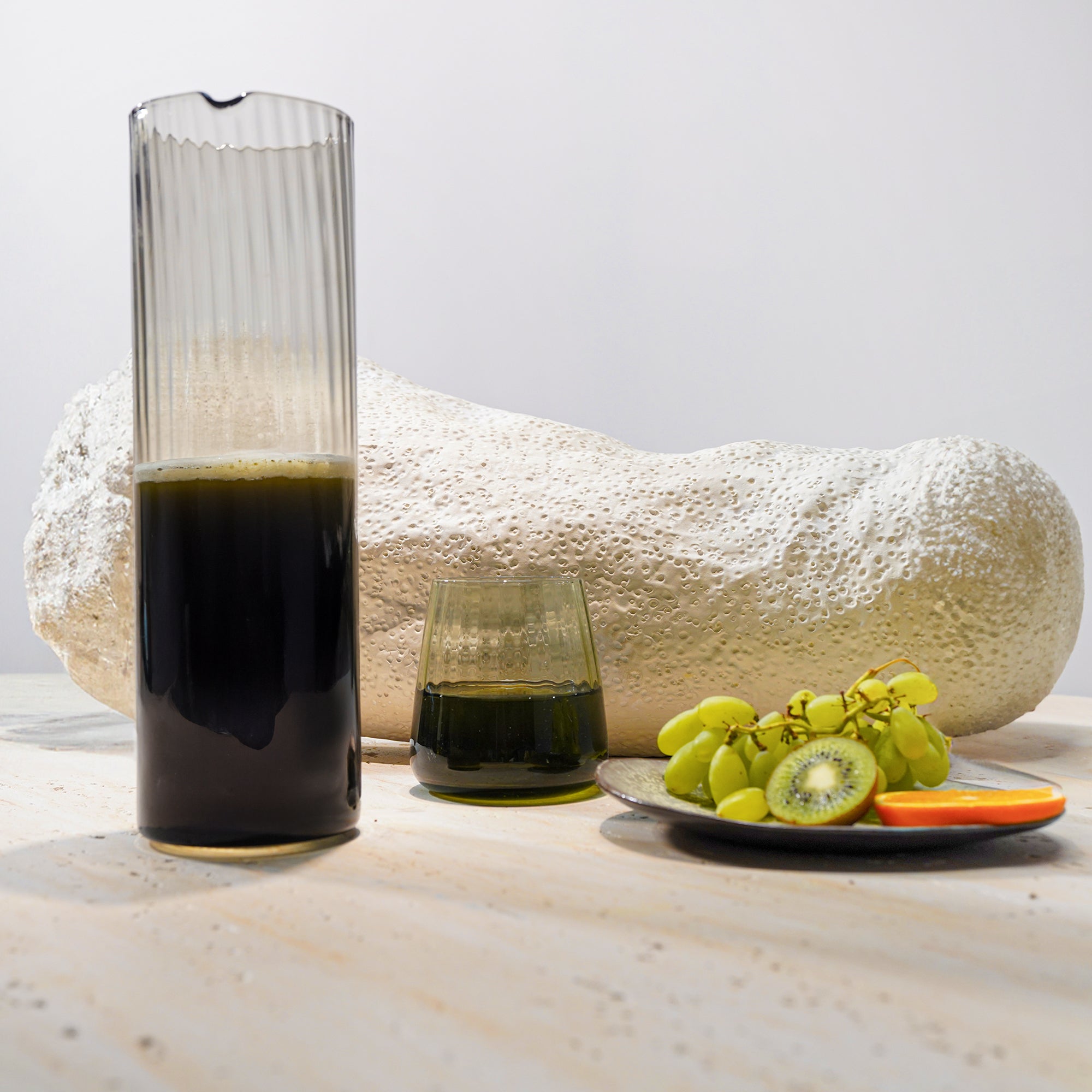 Smoked grey glass carafe with 1.2L capacity, designed by BEACON for elegant drinkware presentation.
