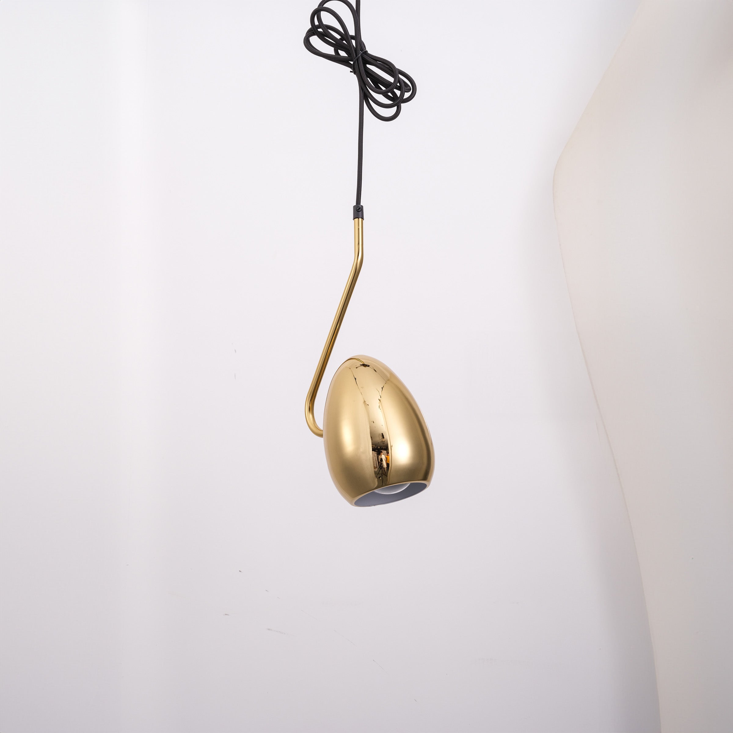 Gold teardrop pendant lamp from BEACON, showcasing a sleek, modern design with a smooth, reflective surface.