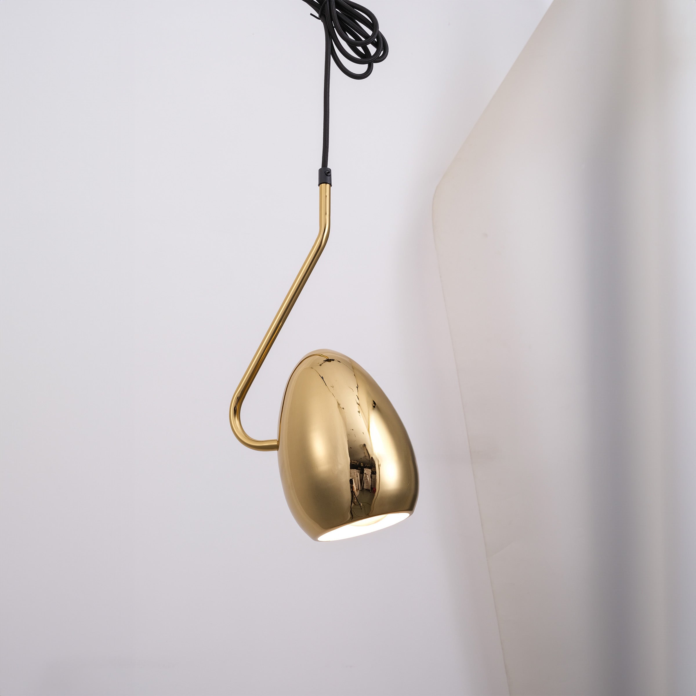 Gold teardrop pendant lamp from BEACON, featuring a sleek, modern design with a shiny finish for stylish interior lighting.