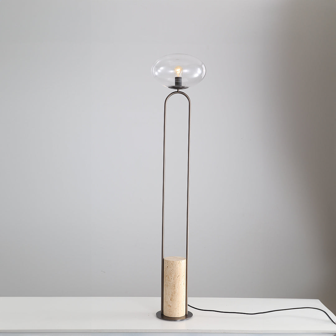 BEACON JA051 travertine floor lamp with a sleek, modern design, featuring a textured stone base and a tall, elegant lampshade.