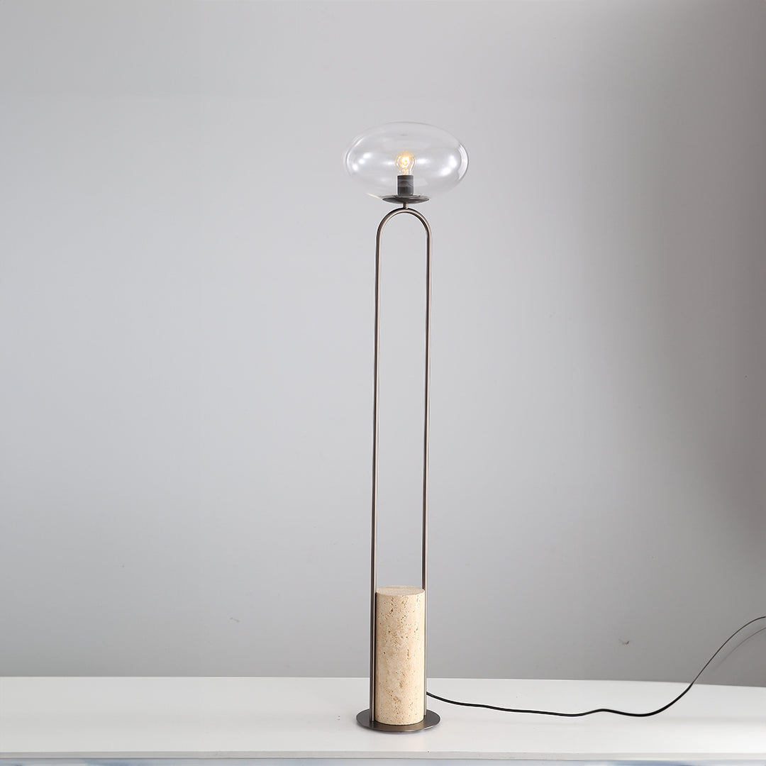 BEACON JA051 travertine floor lamp with a sleek, modern design featuring a textured stone base and a tall, elegant lampshade.
