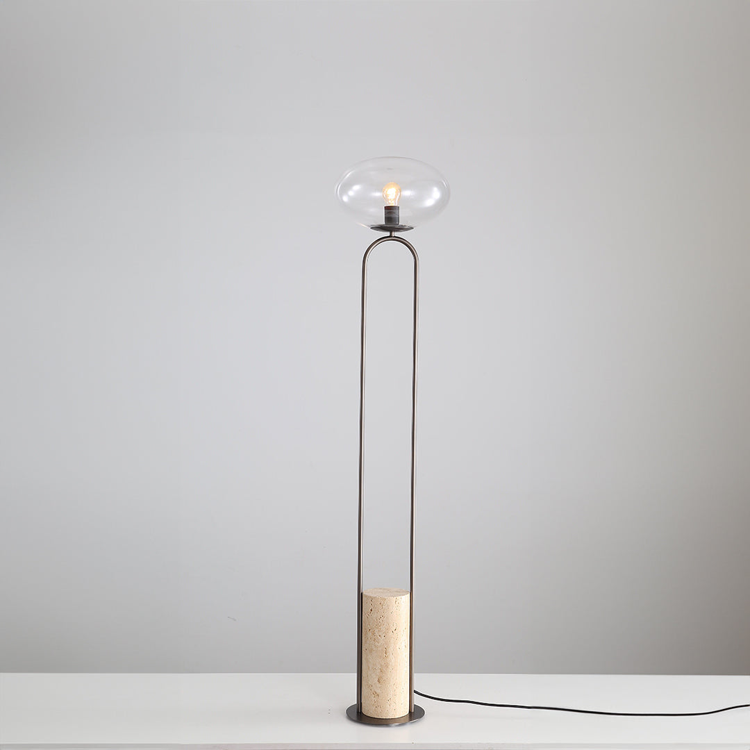 BEACON JA051 travertine floor lamp with a sleek, modern design, featuring a textured stone base and a tall, elegant shade.