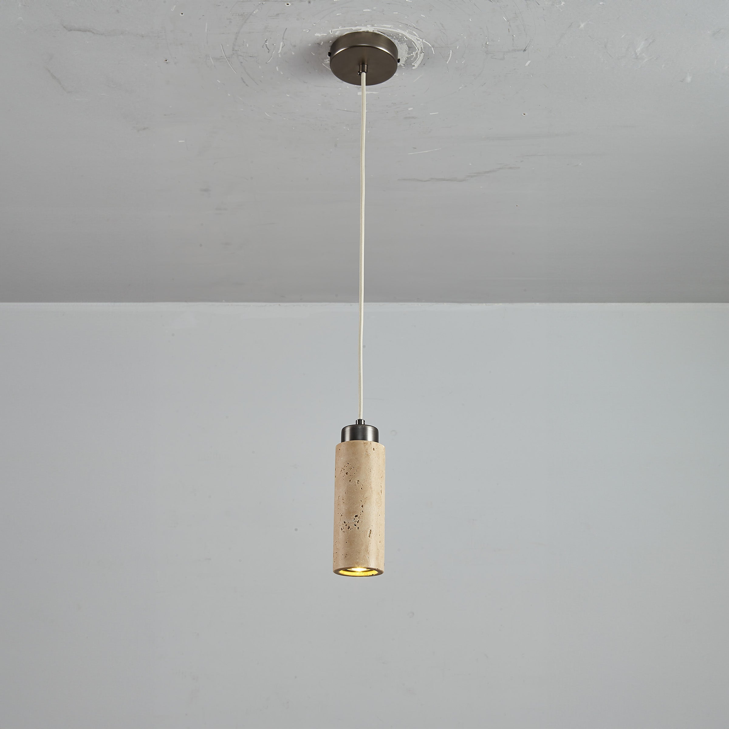 BEACON JIADG travertine pendant lamp 60005-1P with a sleek, natural stone design hanging from a ceiling mount.