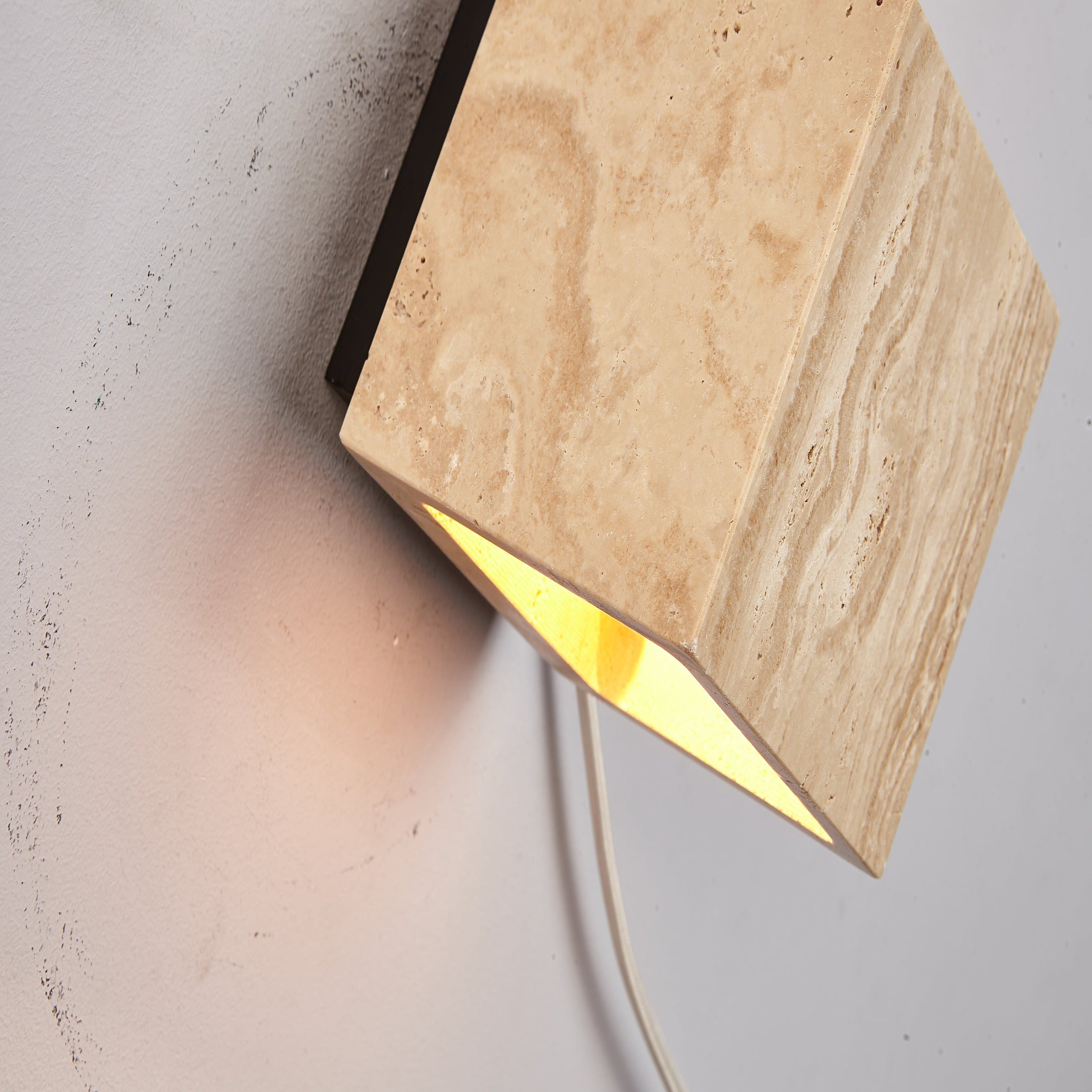 BEACON JIADG travertine wall lamp 60195 mounted on wall, showcasing sleek design and textured stone finish.