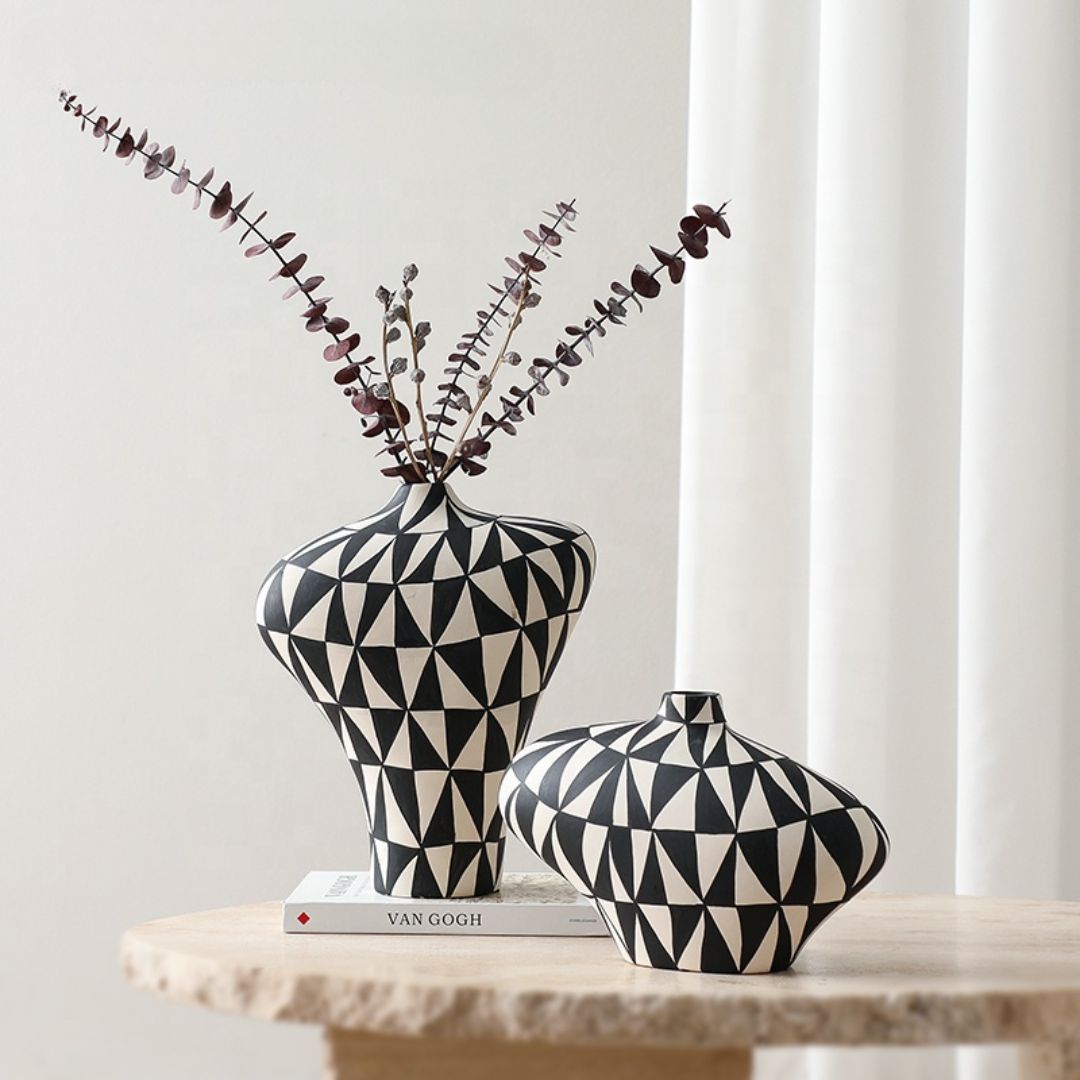 Hand-painted triangular vase by BEACON, featuring vibrant floral designs, made of ceramic, with a unique geometric shape.