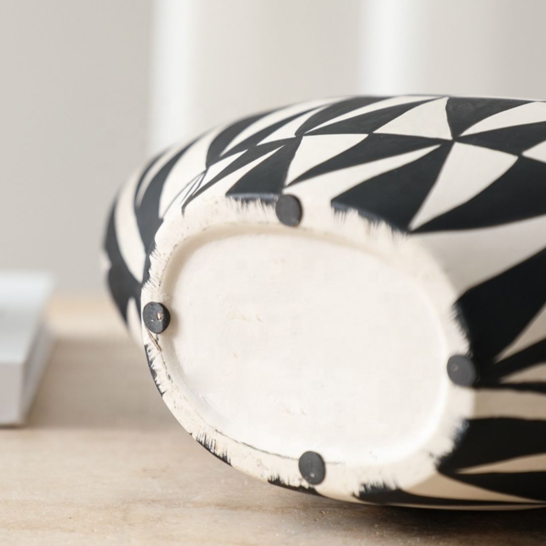 Hand-painted triangular vase by BEACON with colorful geometric patterns, made of ceramic, decorative home accent.