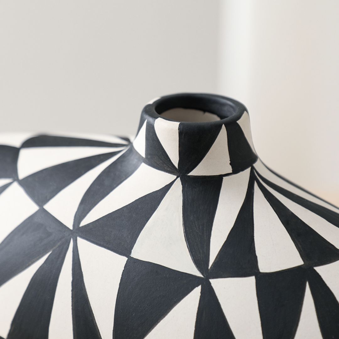 Hand-painted triangular vase by BEACON with colorful floral design, ceramic finish, perfect for decorative display.