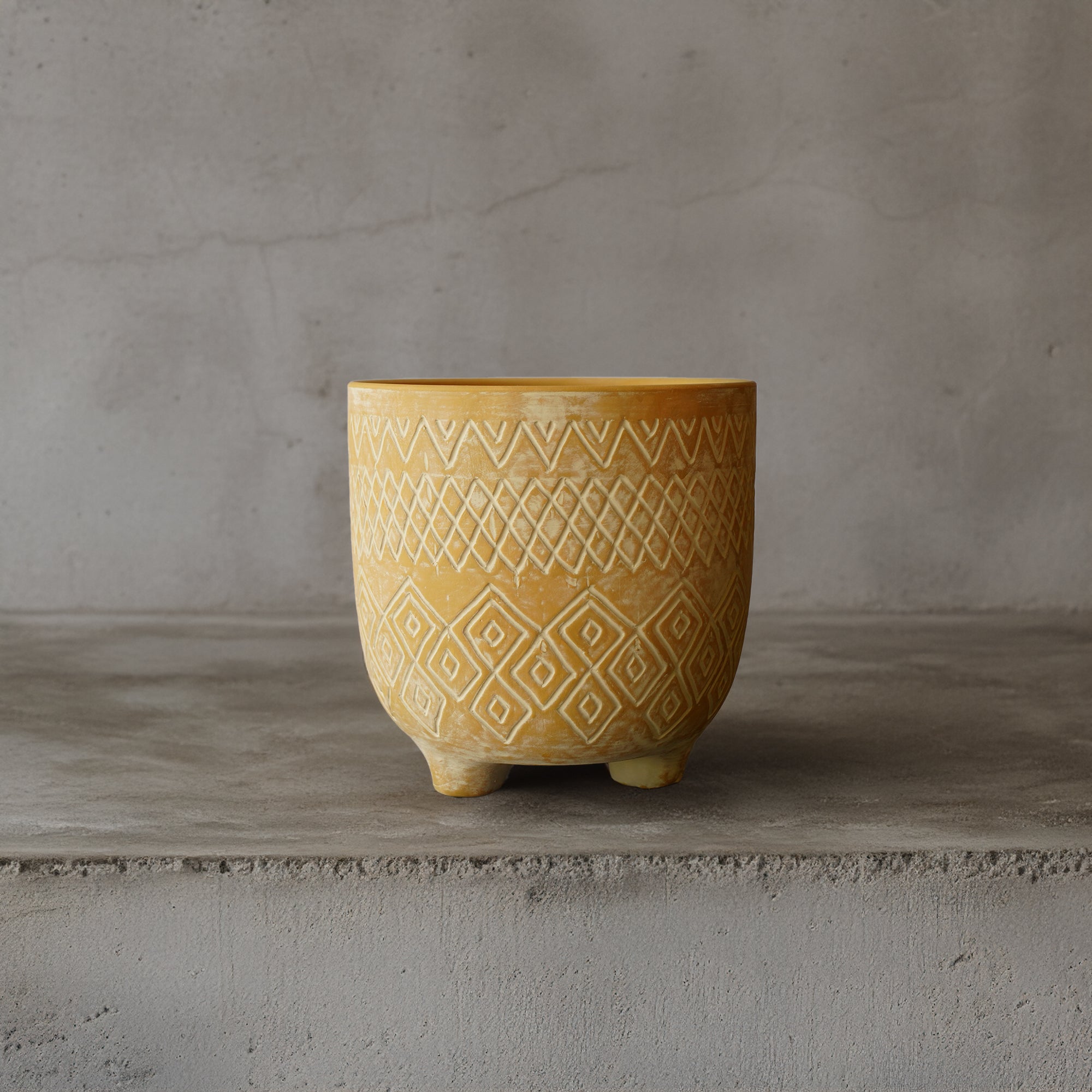 Triangular terracotta planter box for outdoor or indoor use by BEACON, featuring a modern geometric design.
