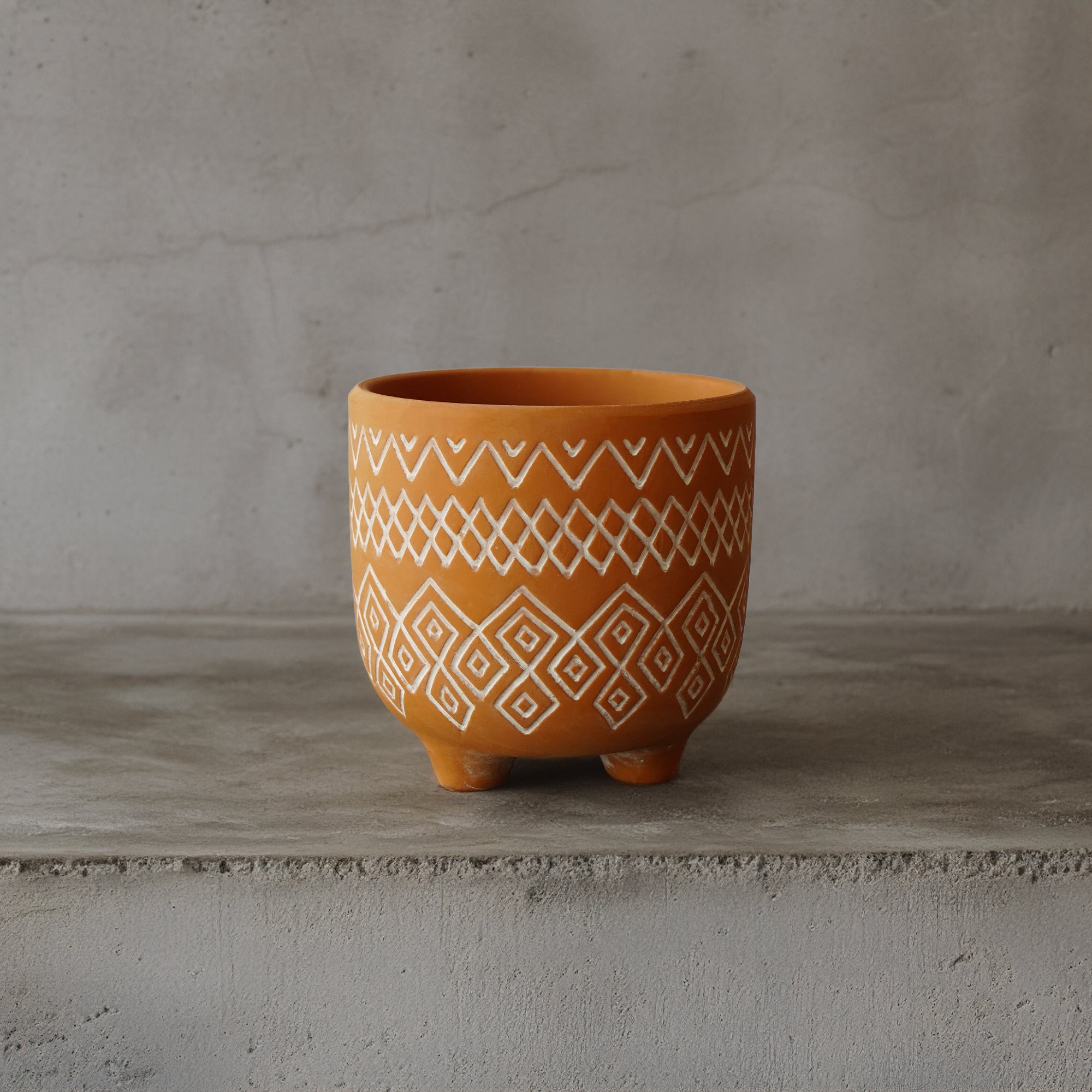 Triangular terracotta outdoor and indoor planter box by BEACON, perfect for plants and decorative displays.