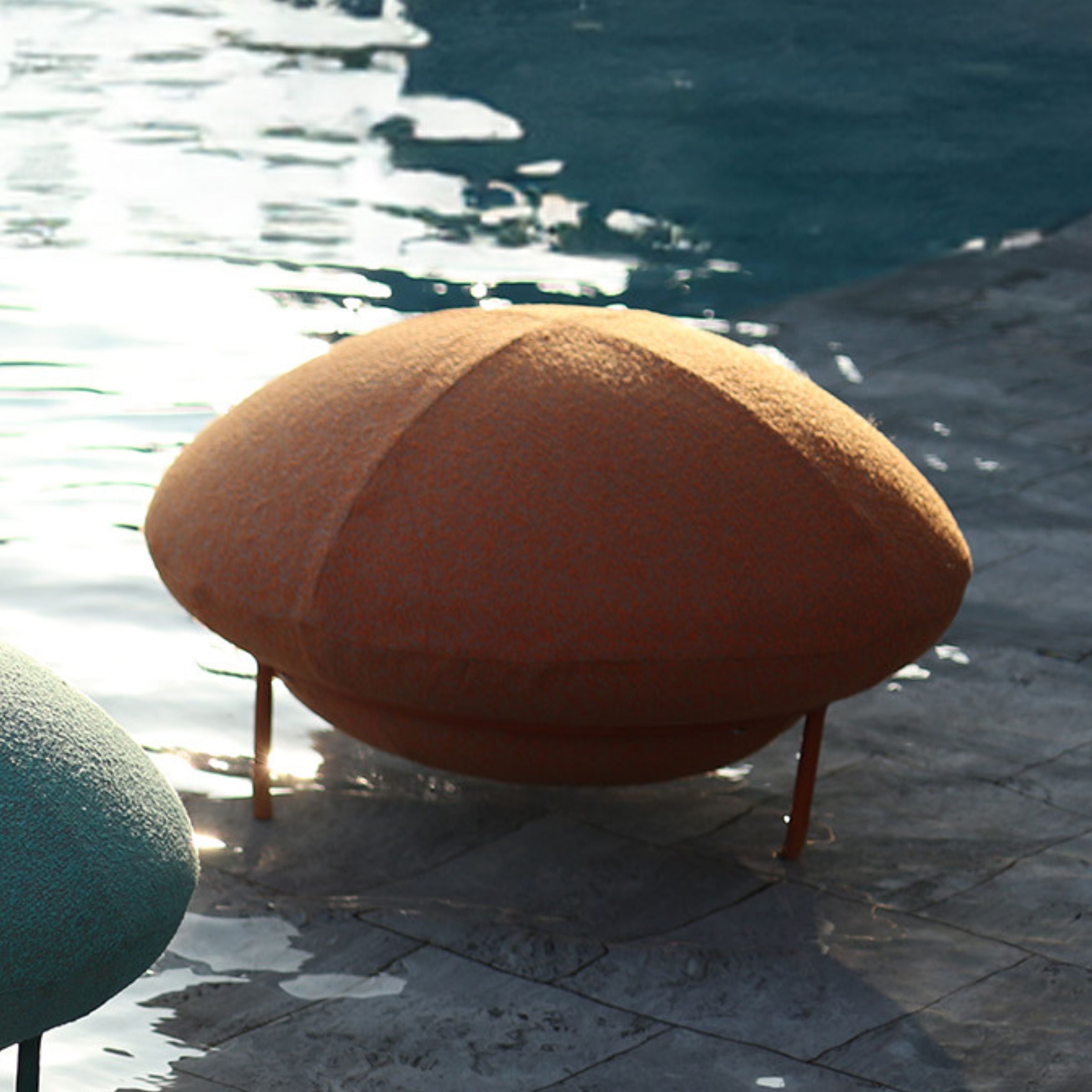 Orange UFO outdoor big stool by BEACON, sturdy outdoor chair with a modern, rounded design for patio or garden use.