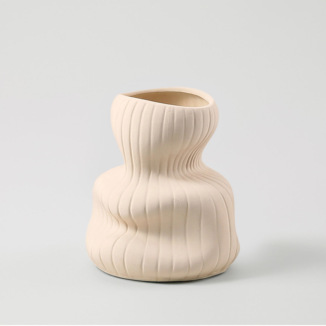 Beige vertical curved vase from BEACON, made of ceramic, featuring a sleek, modern design with a smooth finish.