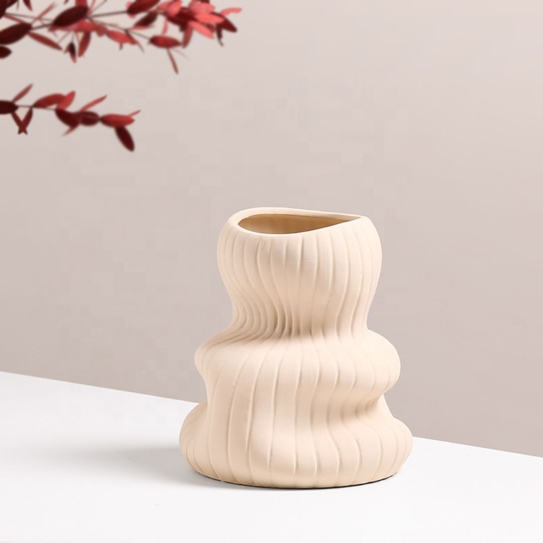 Beige vertical curved vase by BEACON, stylish ceramic vase with a sleek, elongated design and curved silhouette.