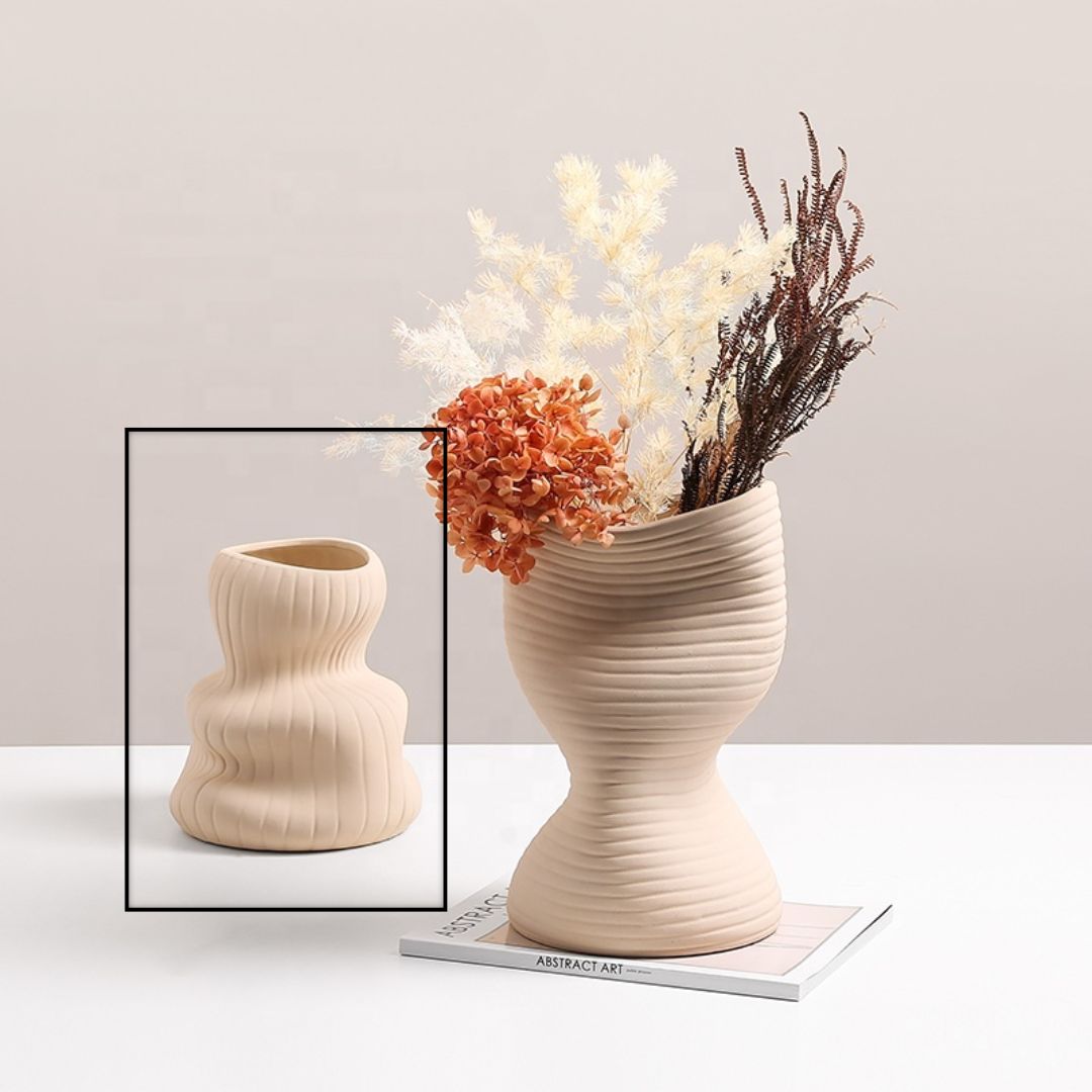 Beige vertical curved vase by BEACON, made of ceramic, with a sleek, modern design suitable for decorative floral displays.