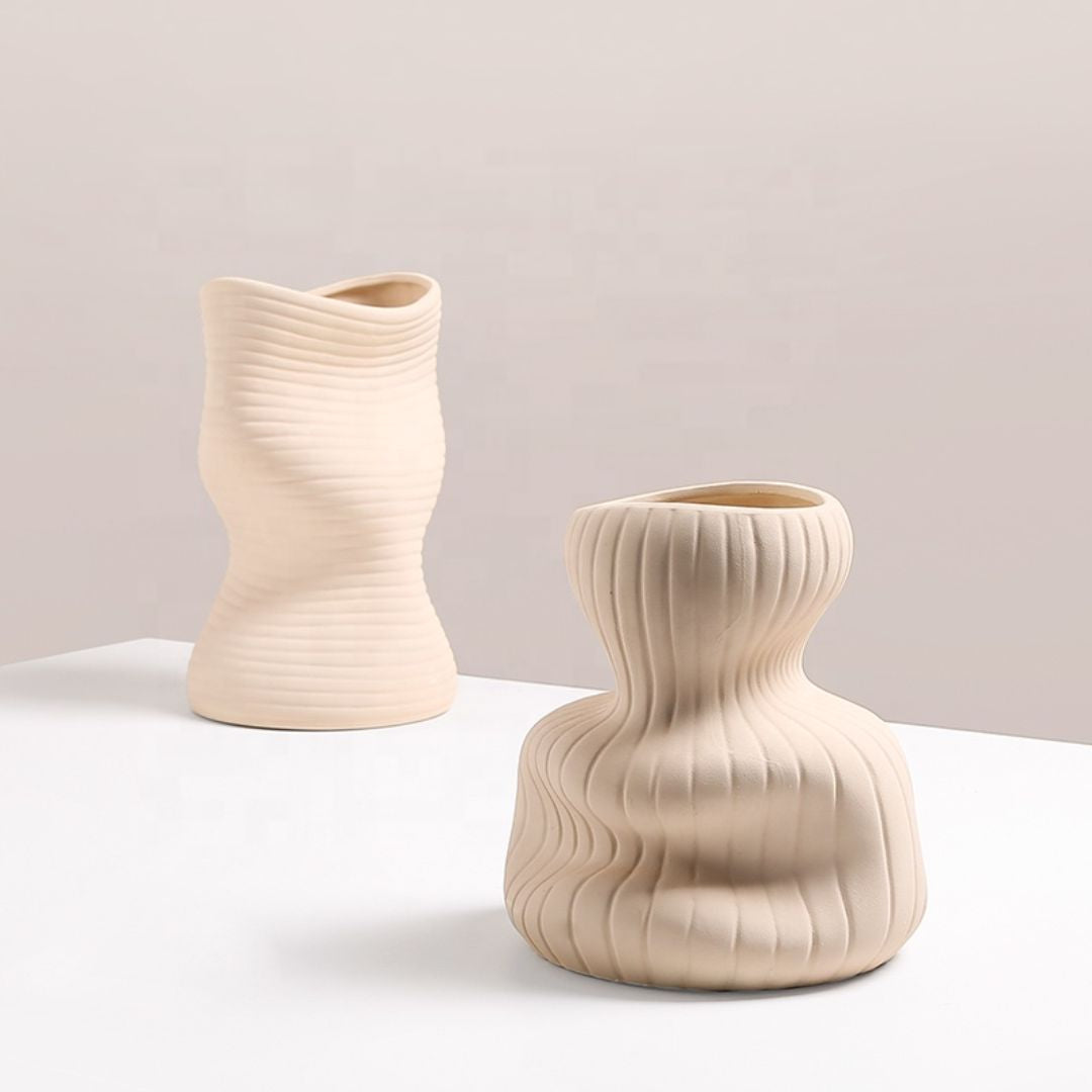 Beige vertical curved vase by BEACON, showcasing its elegant, tall design with a smooth, curved shape suitable for floral arrangements.